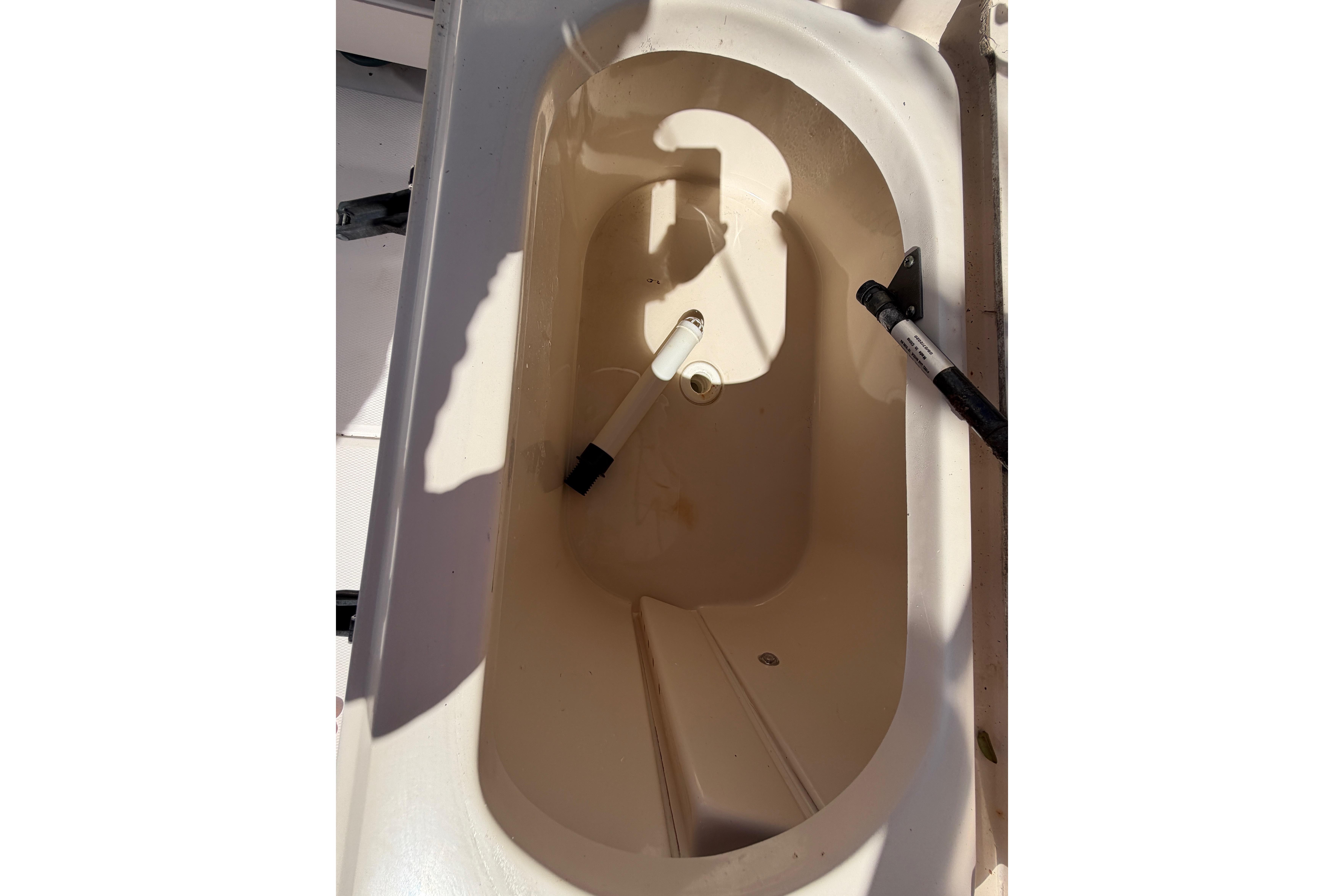 2006 Grady-White Sailfish 282 boat compartment, open and empty, with visible shadows.