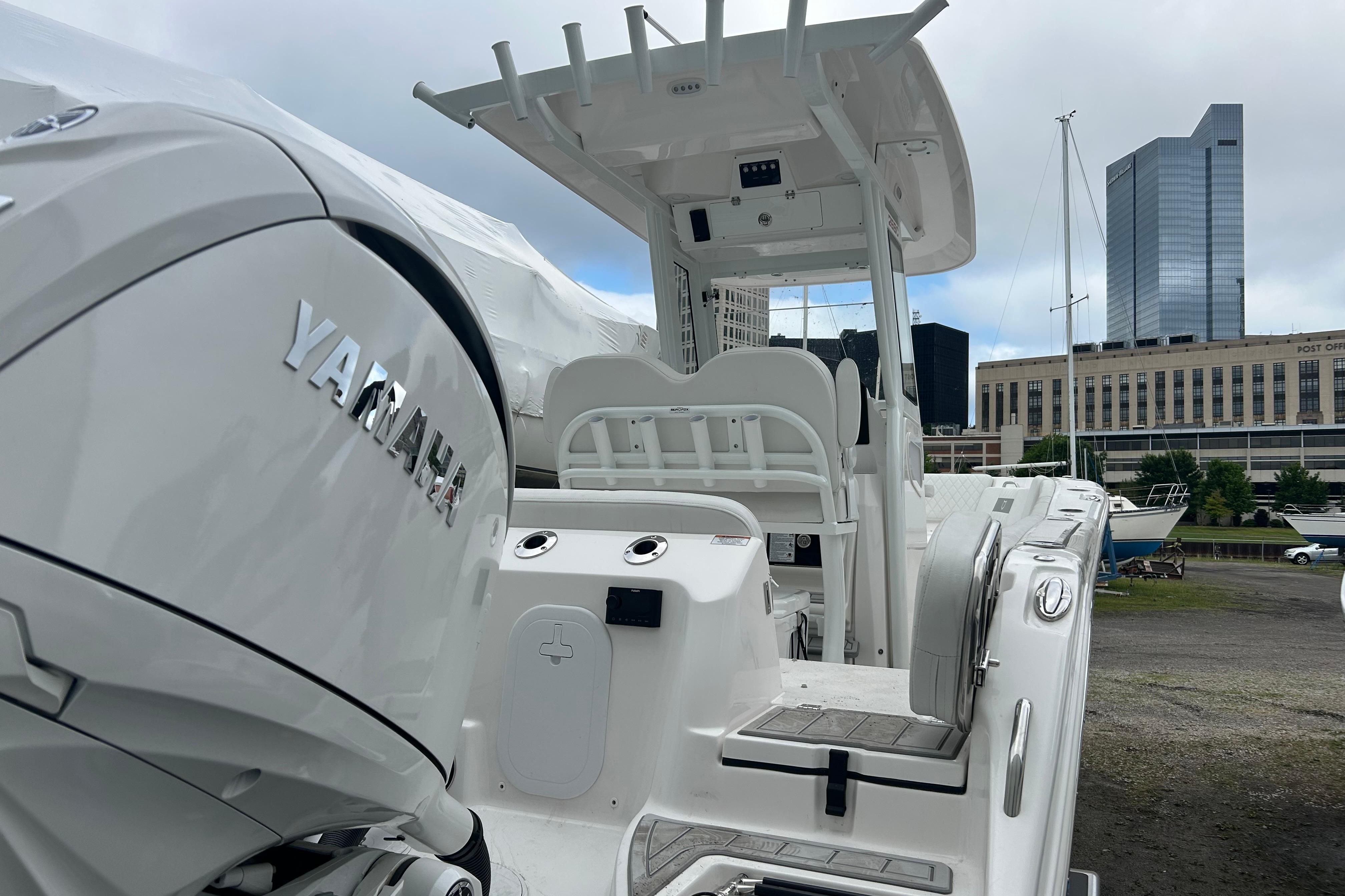 2026 Sea Fox 268 Commander boat with Yamaha engine, docked near urban buildings.