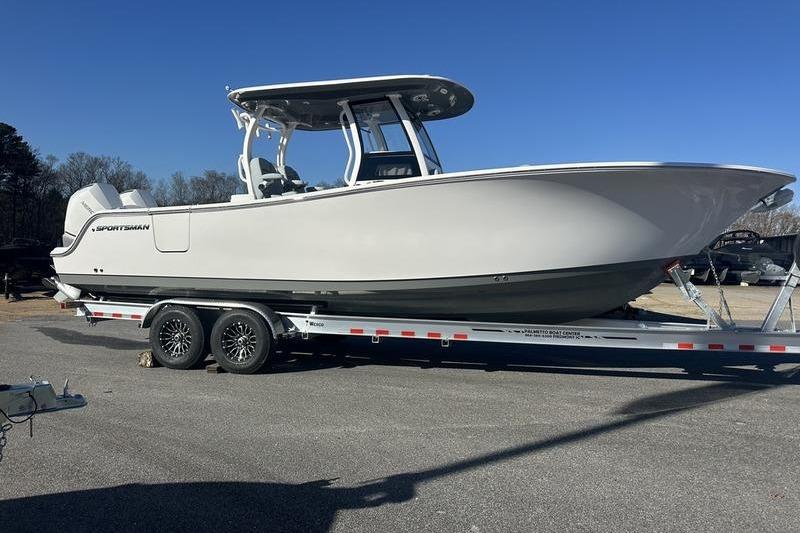2026 Sportsman Open 282 Center Console boat on trailer, parked outdoors.