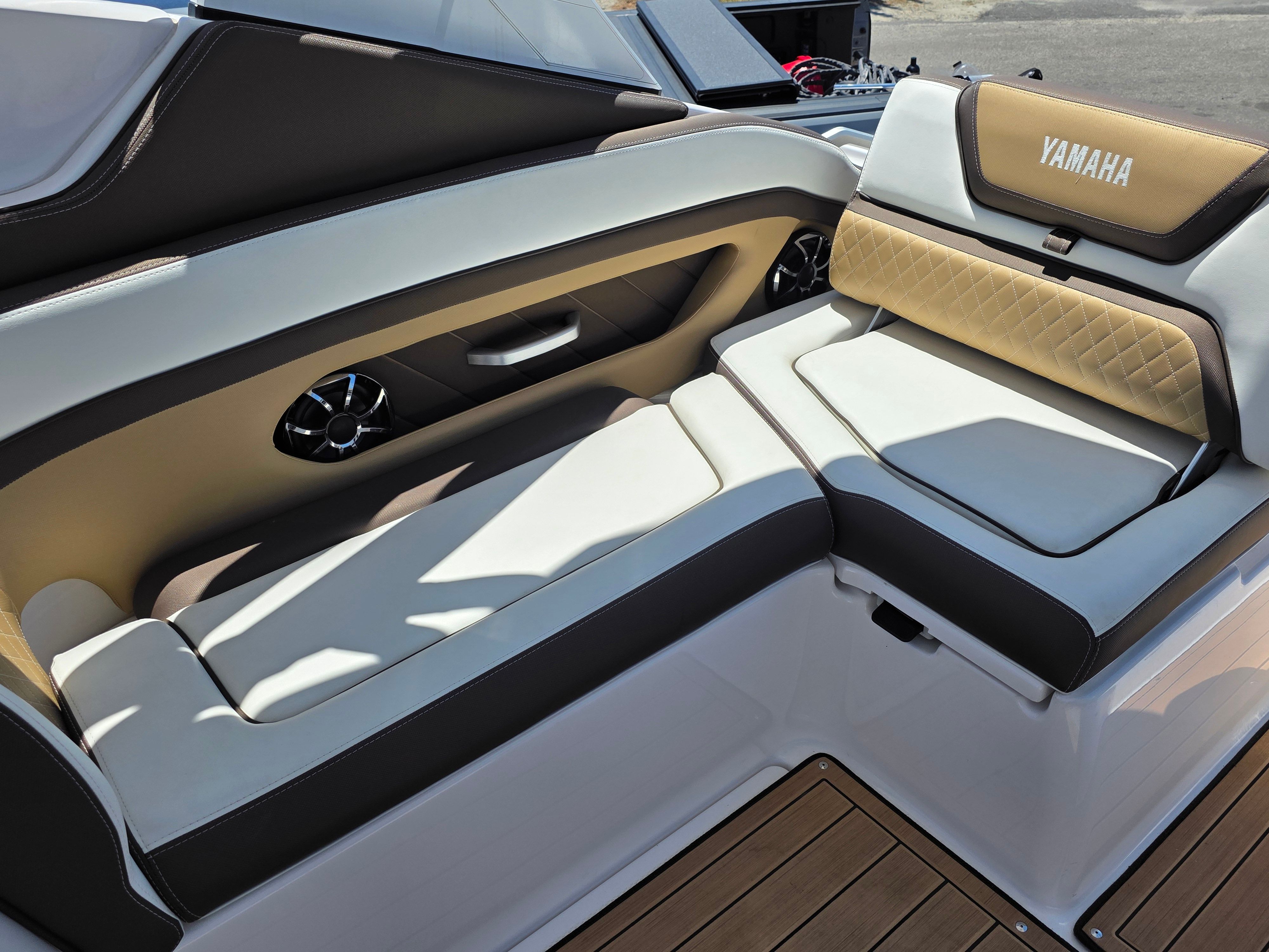 The image shows the luxurious seating area of a 2023 Yamaha Boats sd275 with elegant upholstery.