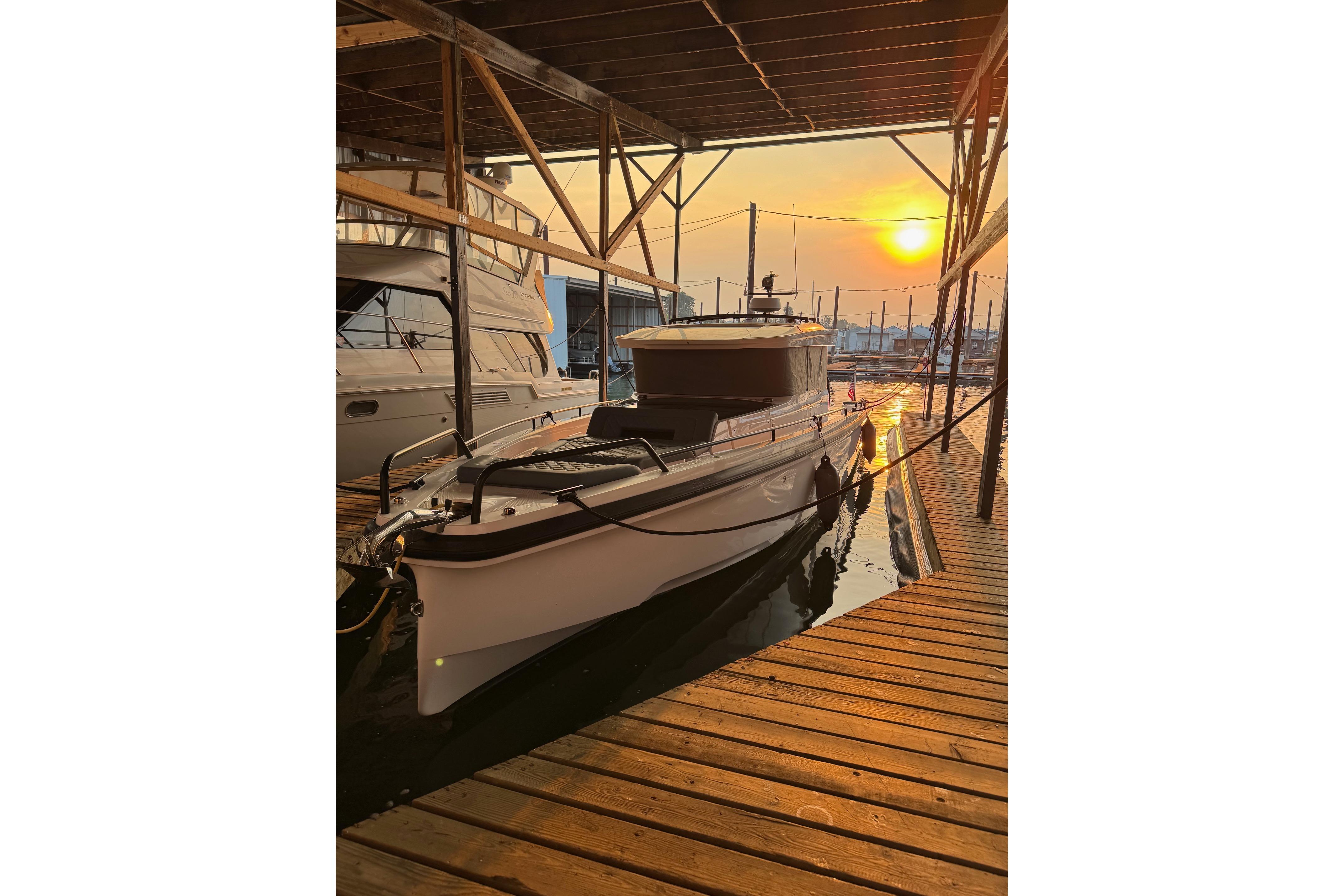 2022 Axopar Brabus 37 XC Cross Cabin docked at sunset.