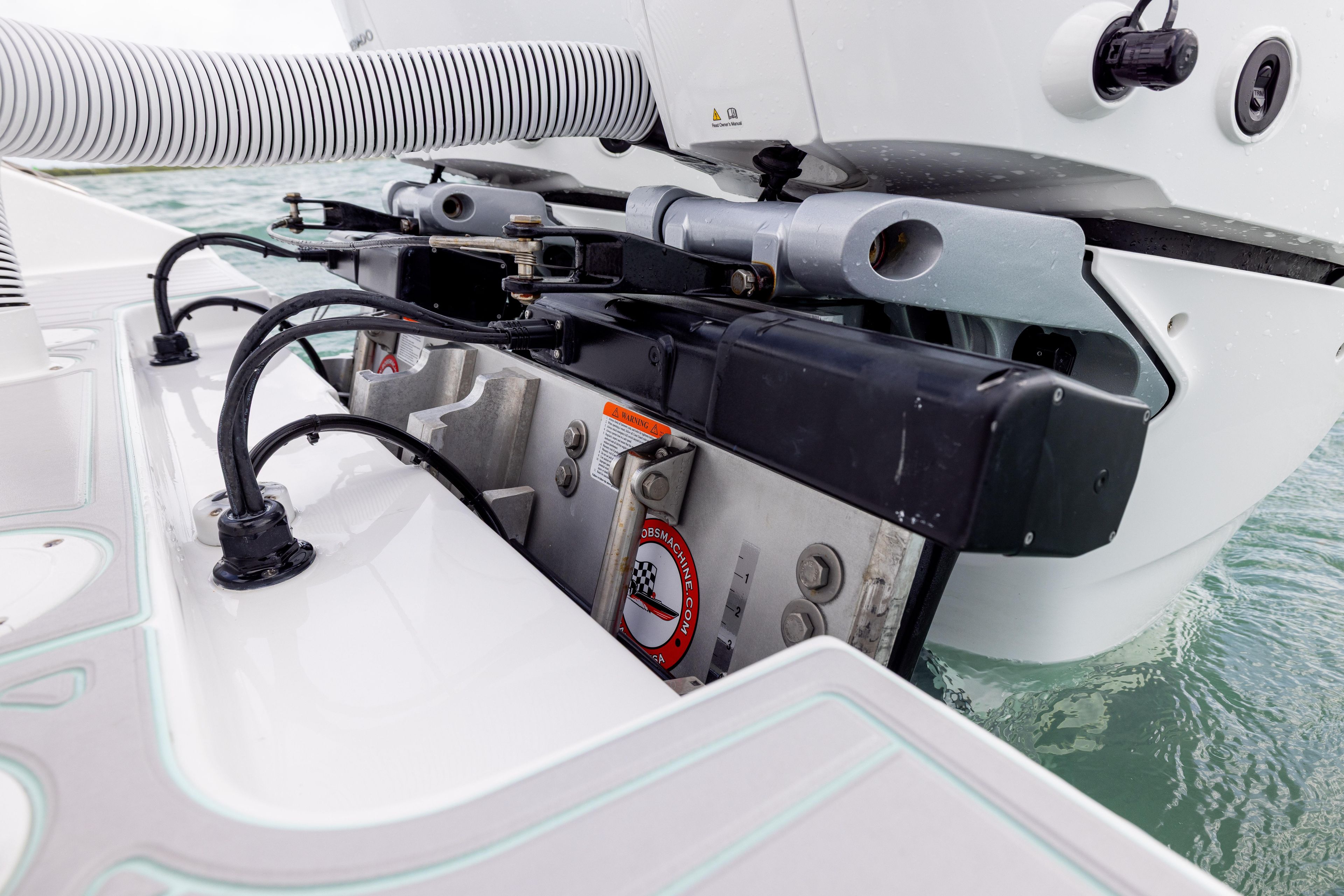 Close-up of 2025 SeaHunter 30 Floridian boat engine components on water.