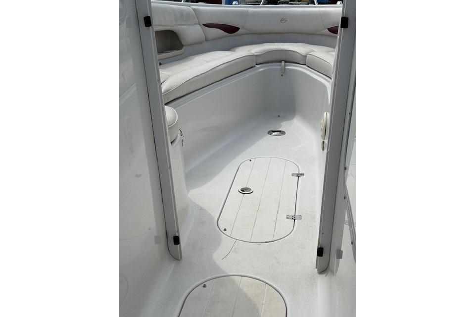 Interior view of 2004 Crownline 288 BR boat, featuring spacious seating and clean deck.
