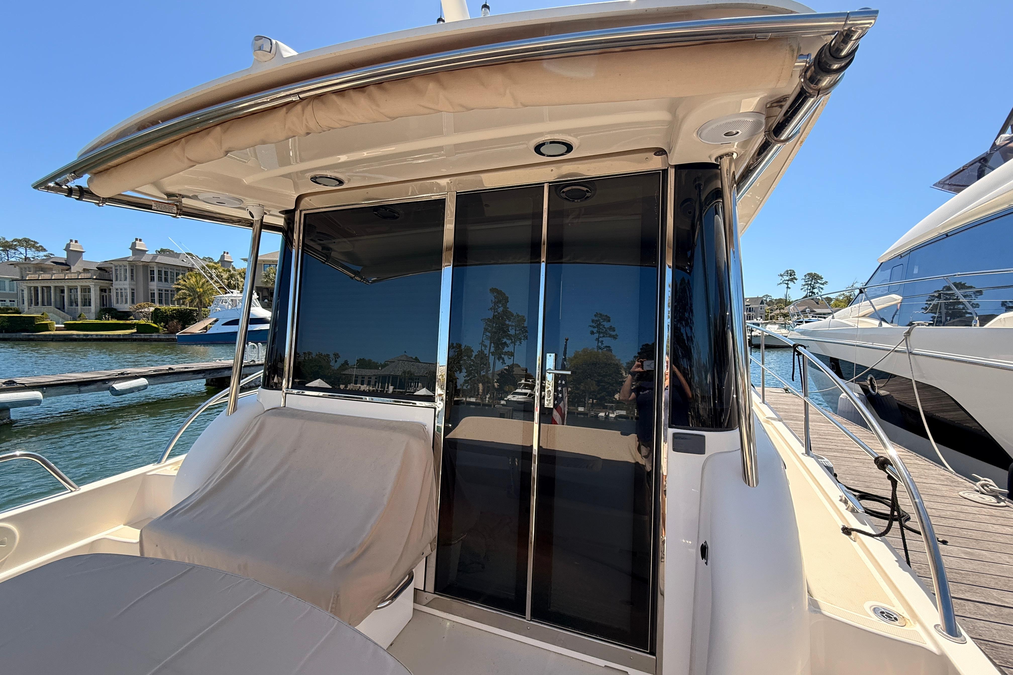 2022 Sabre 38 Salon Express yacht docked, featuring sleek design and spacious seating area.