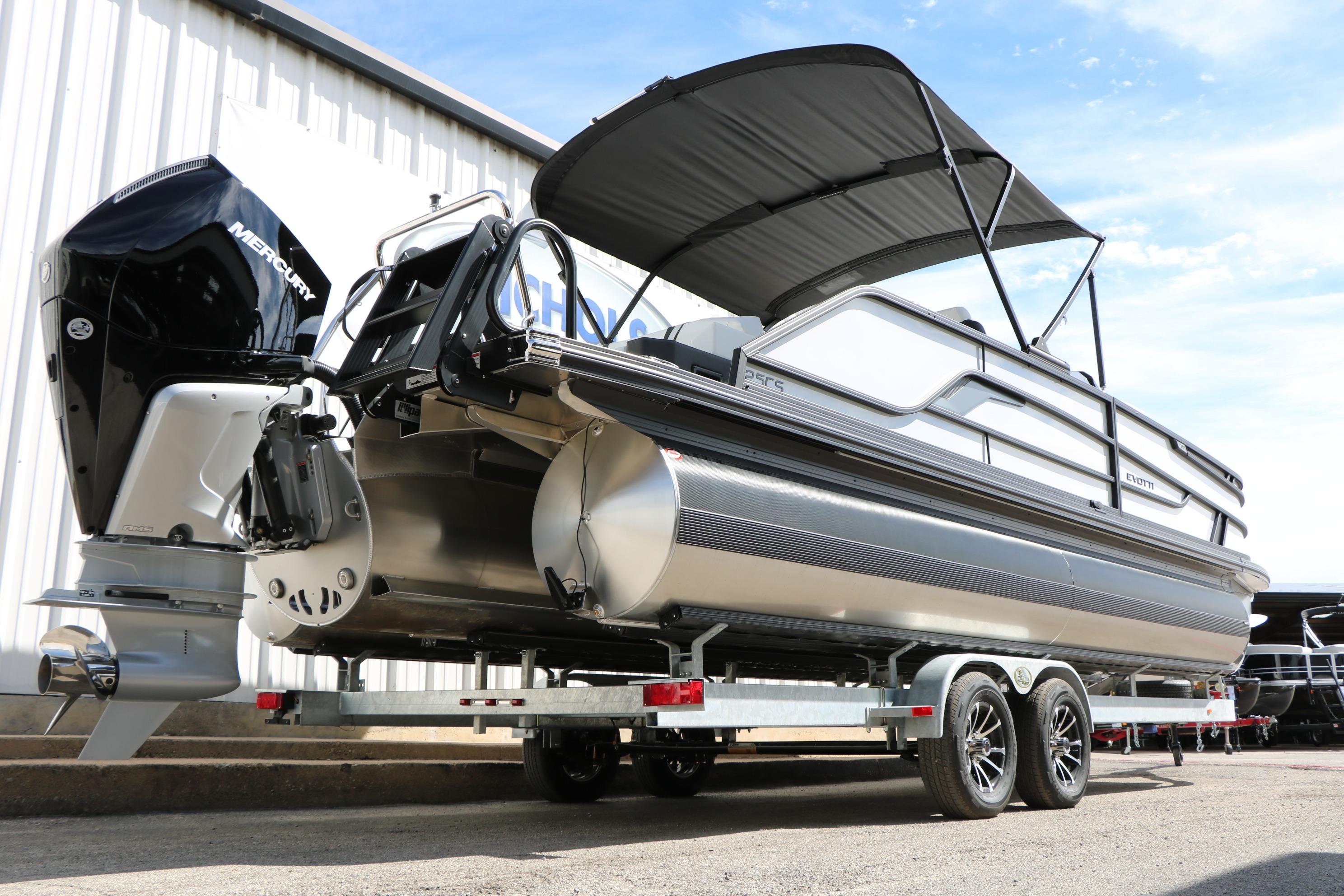 2026 Evotti 725 CS Tri-Toon boat on trailer, featuring sleek design and powerful engine.