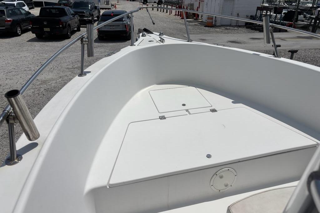 2002 Seaswirl Striper 2101 Center Console O/B boat deck with storage compartments.