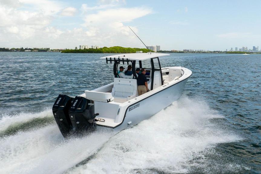 2027 Reef Runner 340 boat cruising on open water with dual engines.
