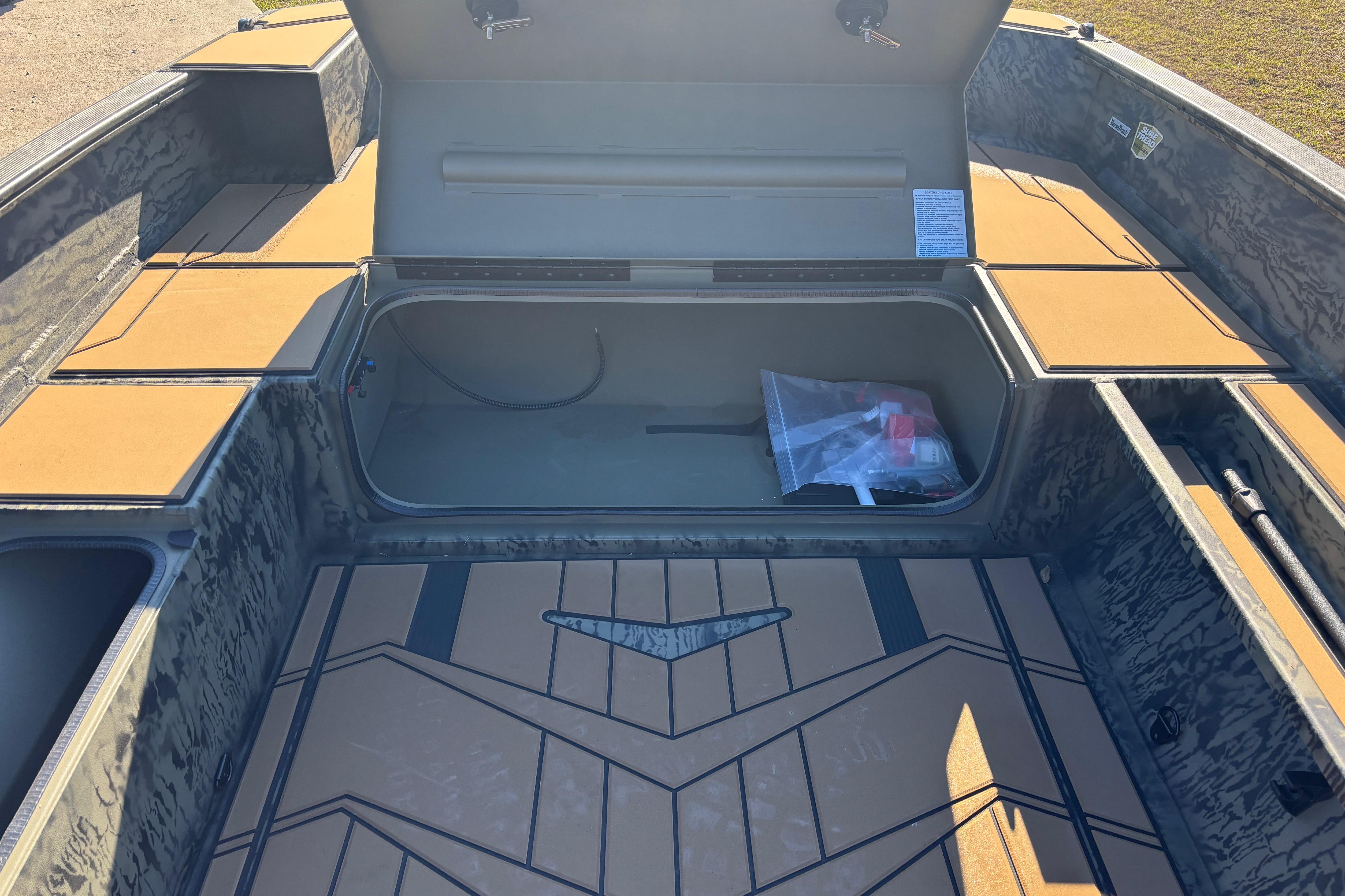 2026 Tracker Grizzly 1756 T Marsh boat interior with open storage compartments.