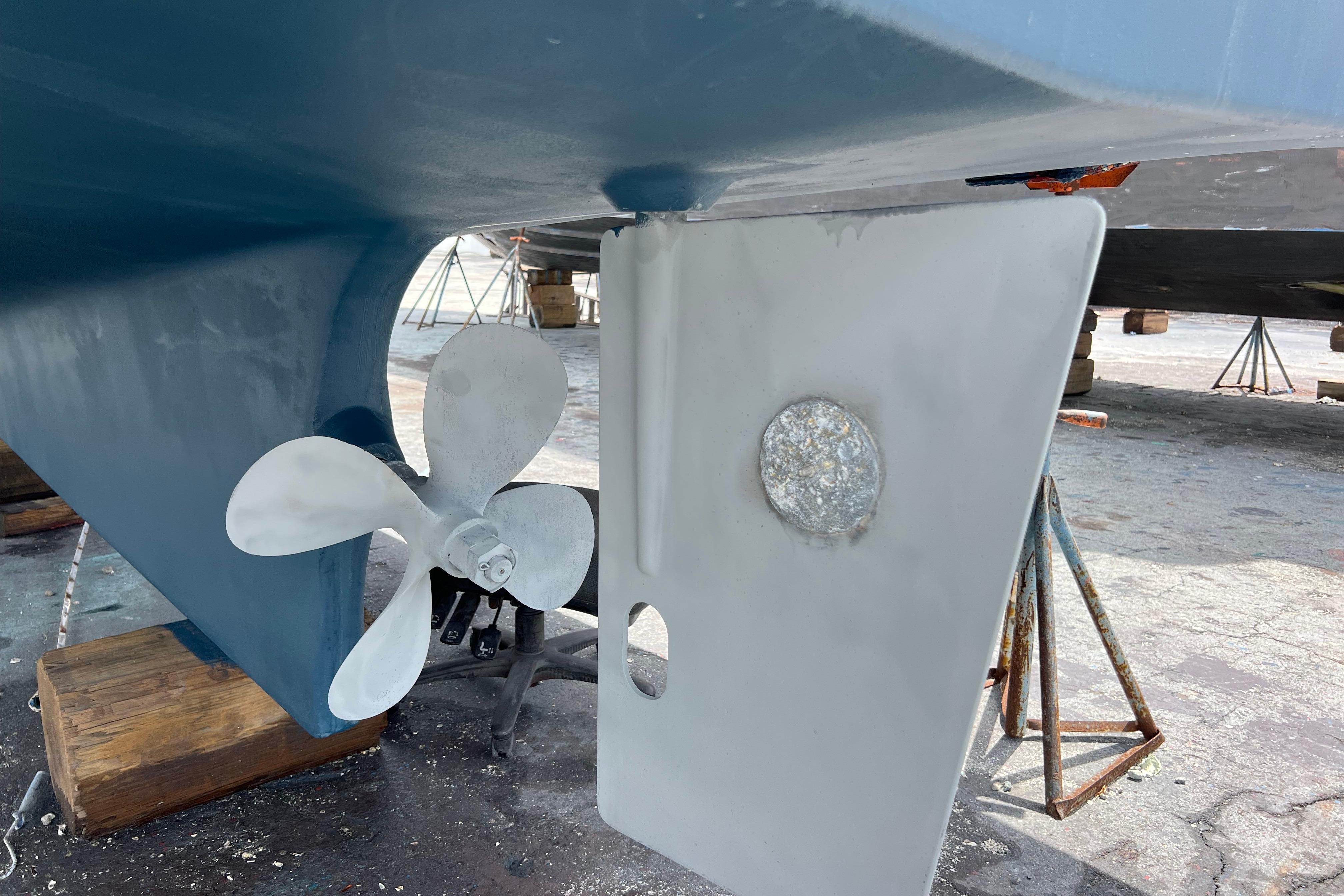 Propeller and rudder of 2007 Heritage East 36 Sundeck Trawler on dry dock.