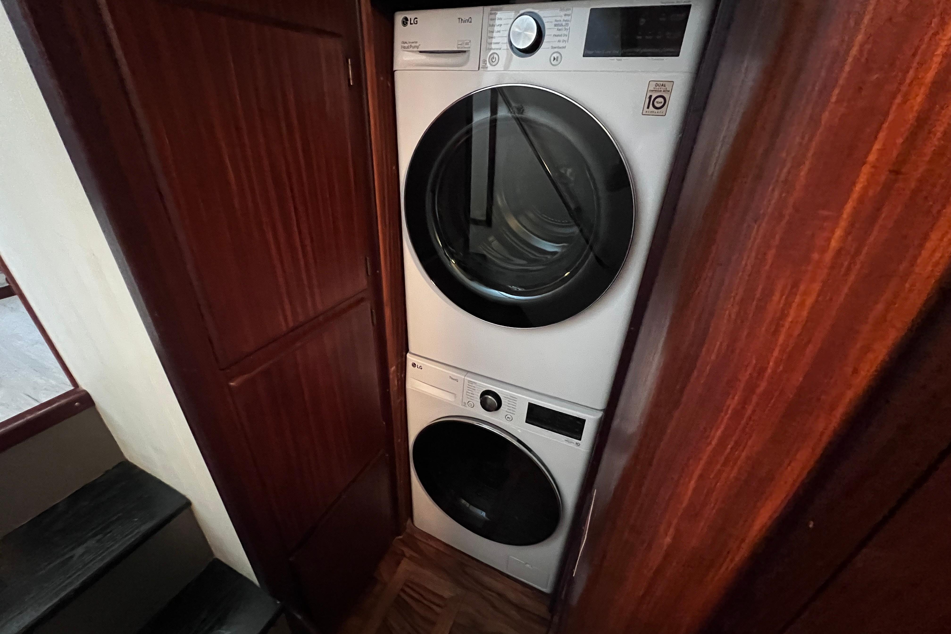 Stacked washer and dryer in 1987 Hatteras 70 Cockpit Motor Yacht interior.