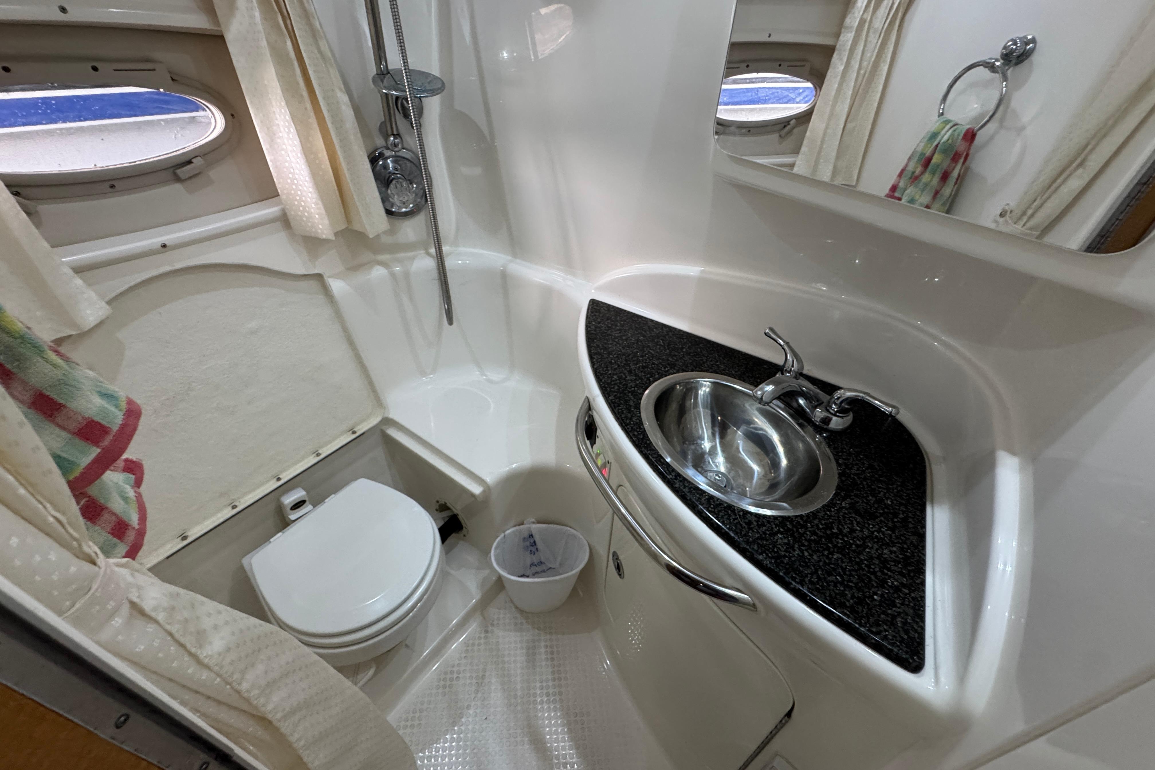 Bathroom interior of 2006 Chaparral 330 Signature boat with sink, toilet, and shower.