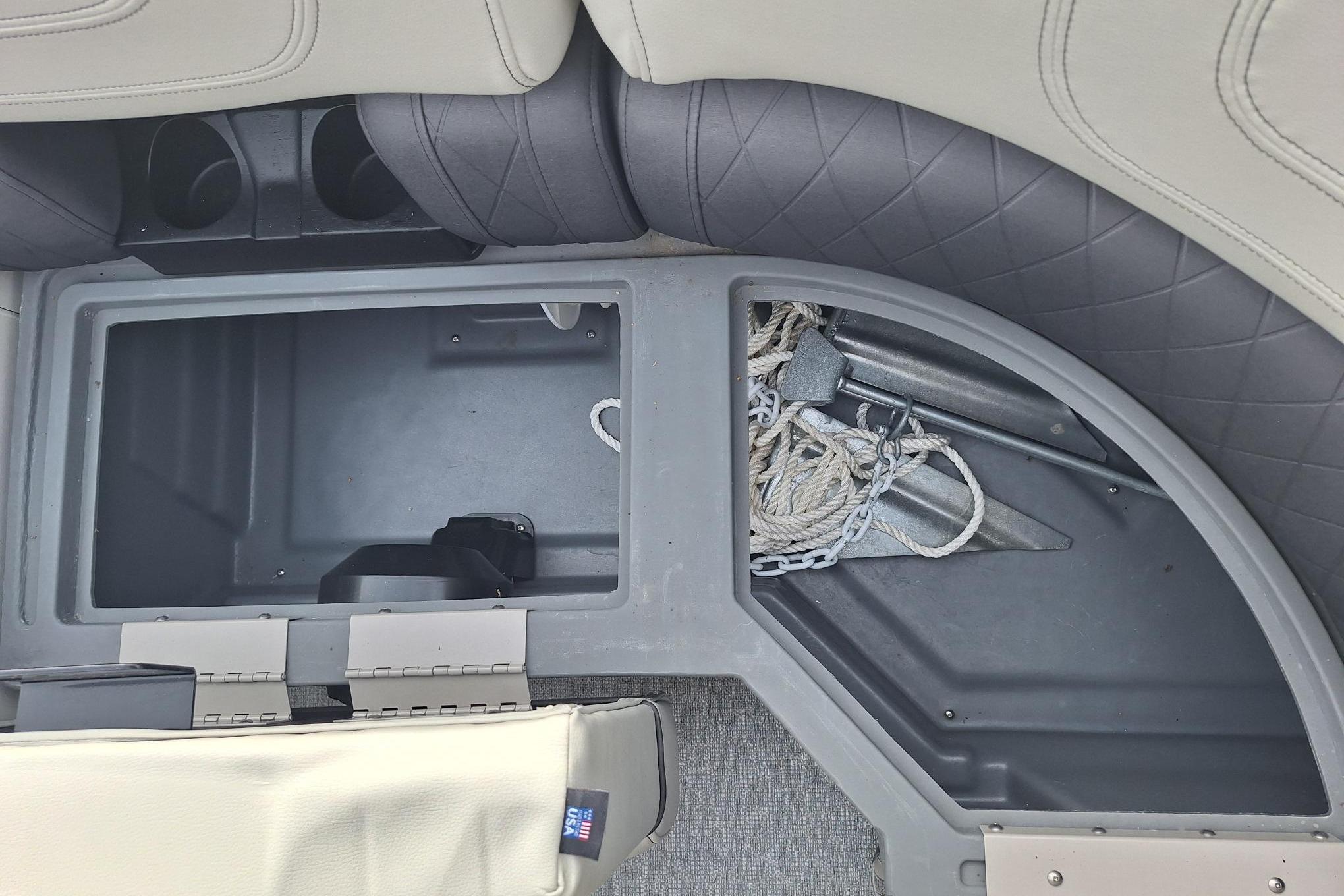 Storage compartment in a 2022 Starcraft SLS 1 boat, featuring anchor and rope.