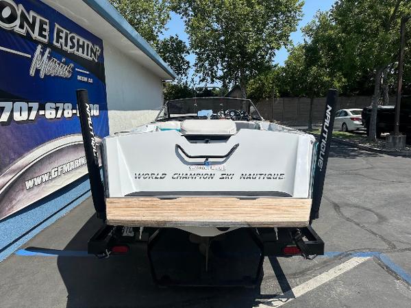 1992 Correct Craft Ski Nautique boat parked outside a marine shop.