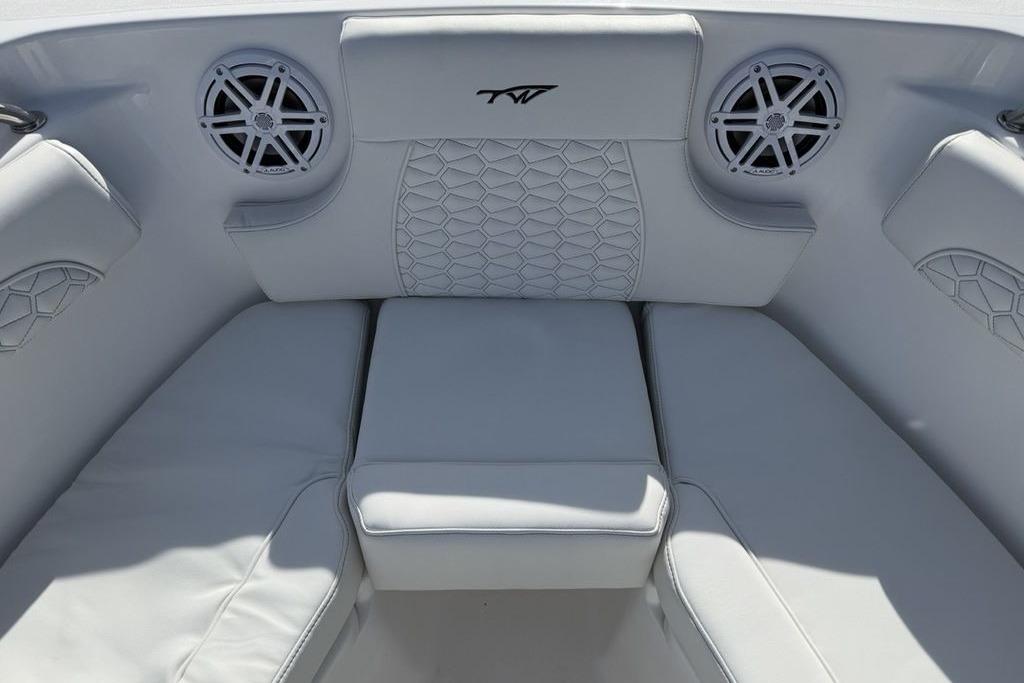 Luxurious seating area on 2026 Tidewater 232 LXF boat with stylish speakers.