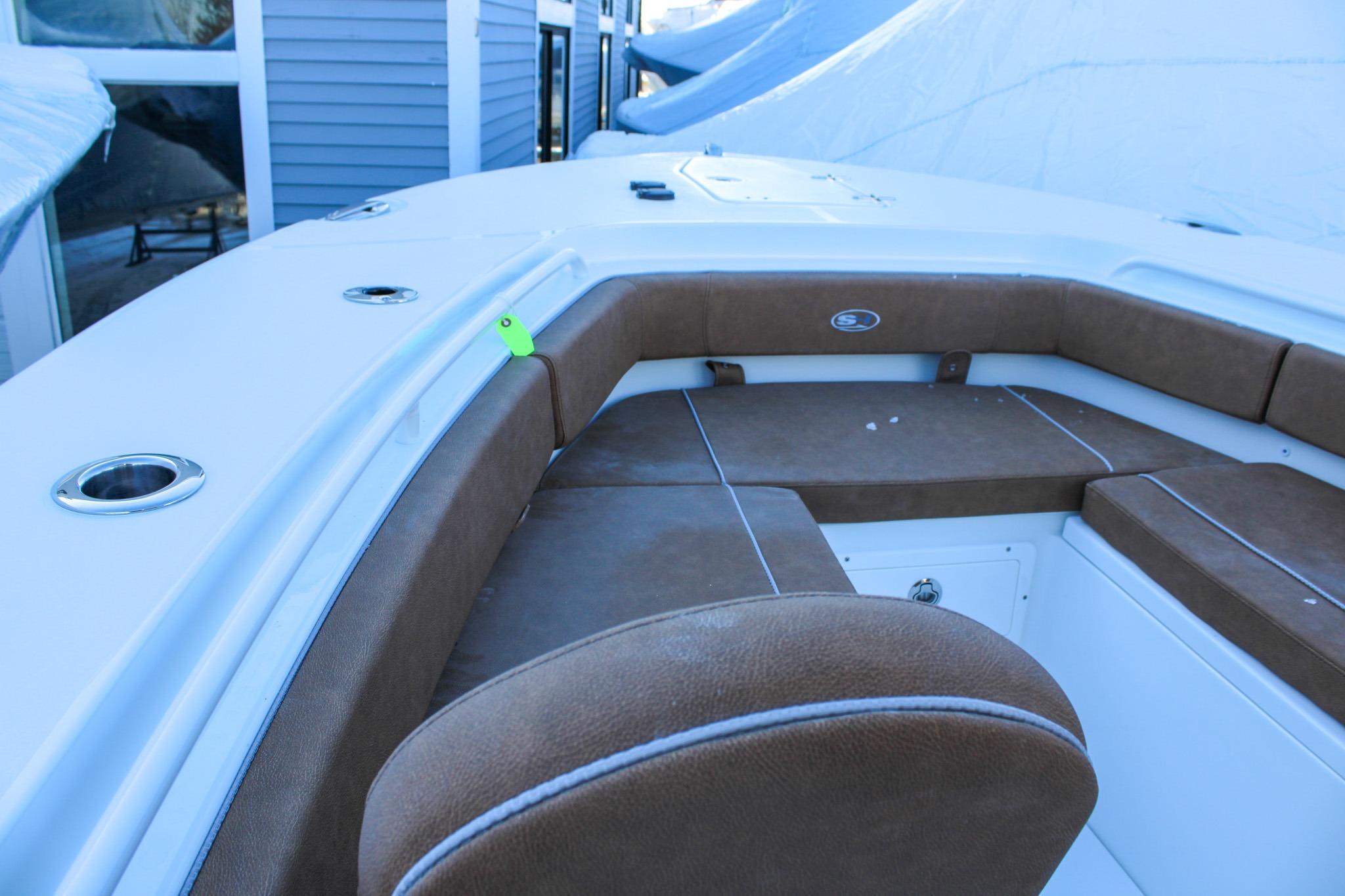 2026 Sea Hunt Gamefish 25 boat interior with brown seating and cup holders.