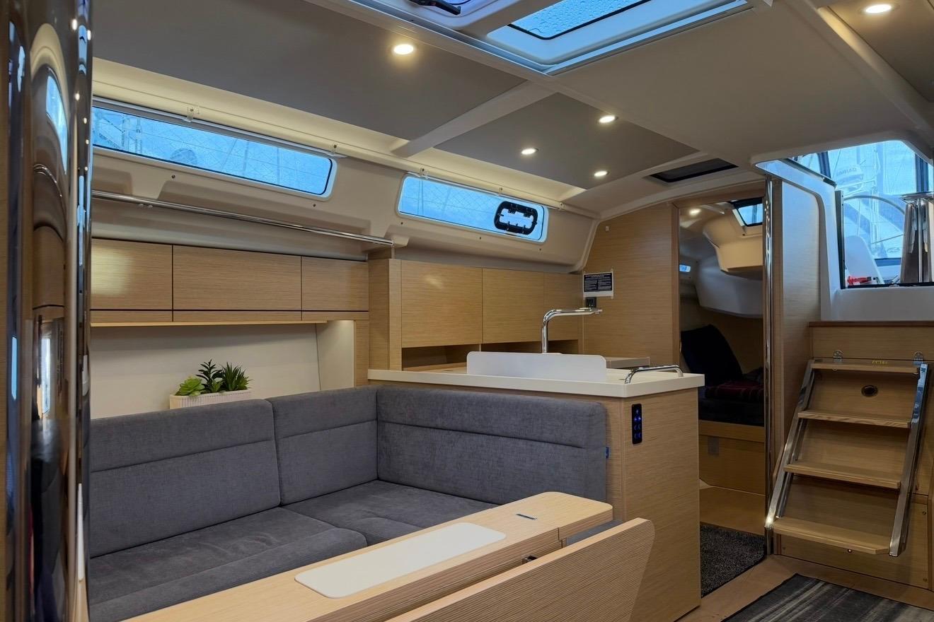 Modern interior of 2022 Hanse 418 yacht with sleek design and cozy seating area.