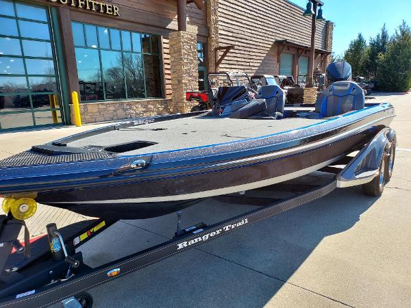 2023 Ranger Z520R boat on trailer outside a rustic building.