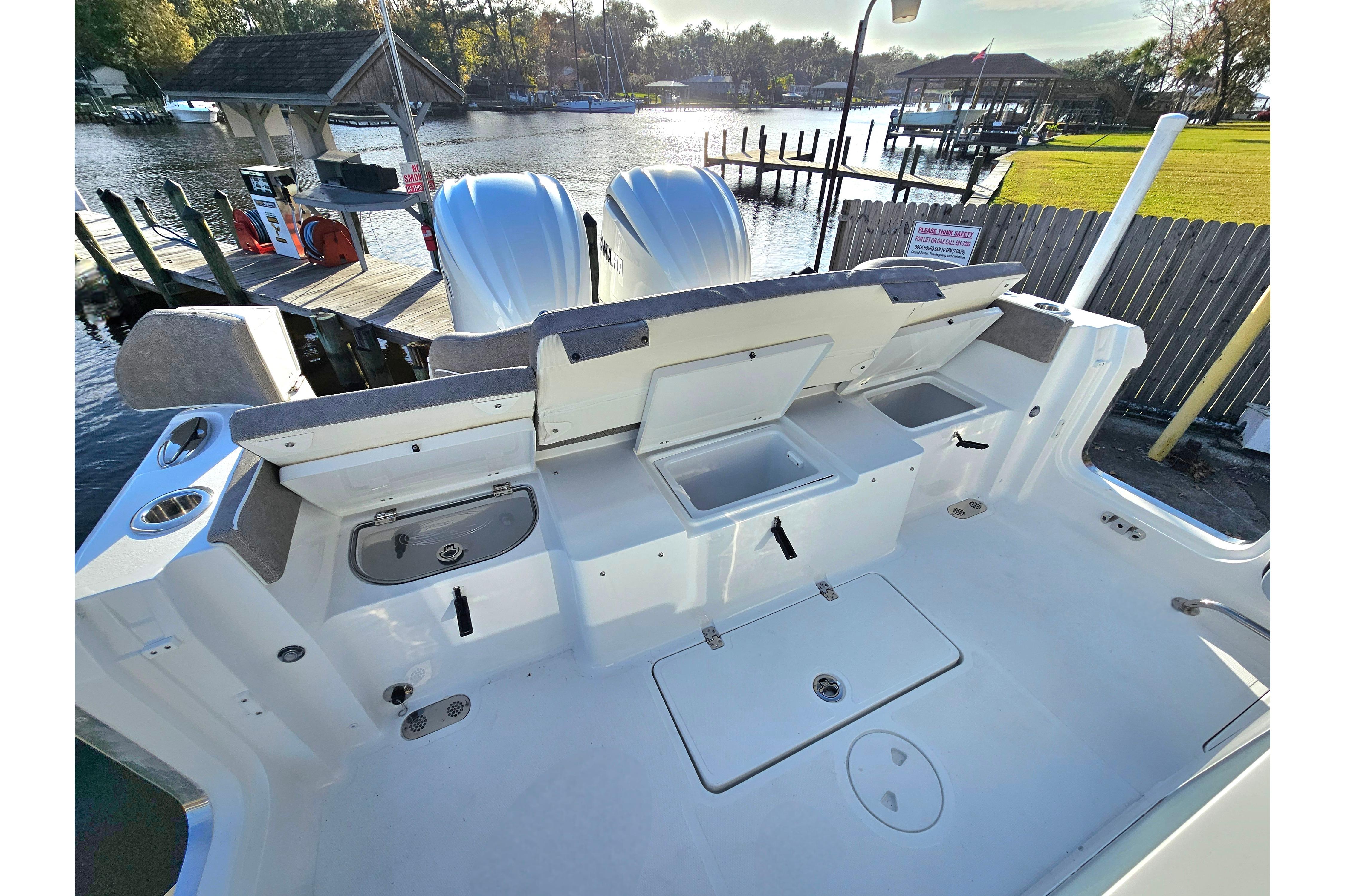 2026 Sea Hunt Ultra 285 SE boat deck with storage compartments and dual engines.