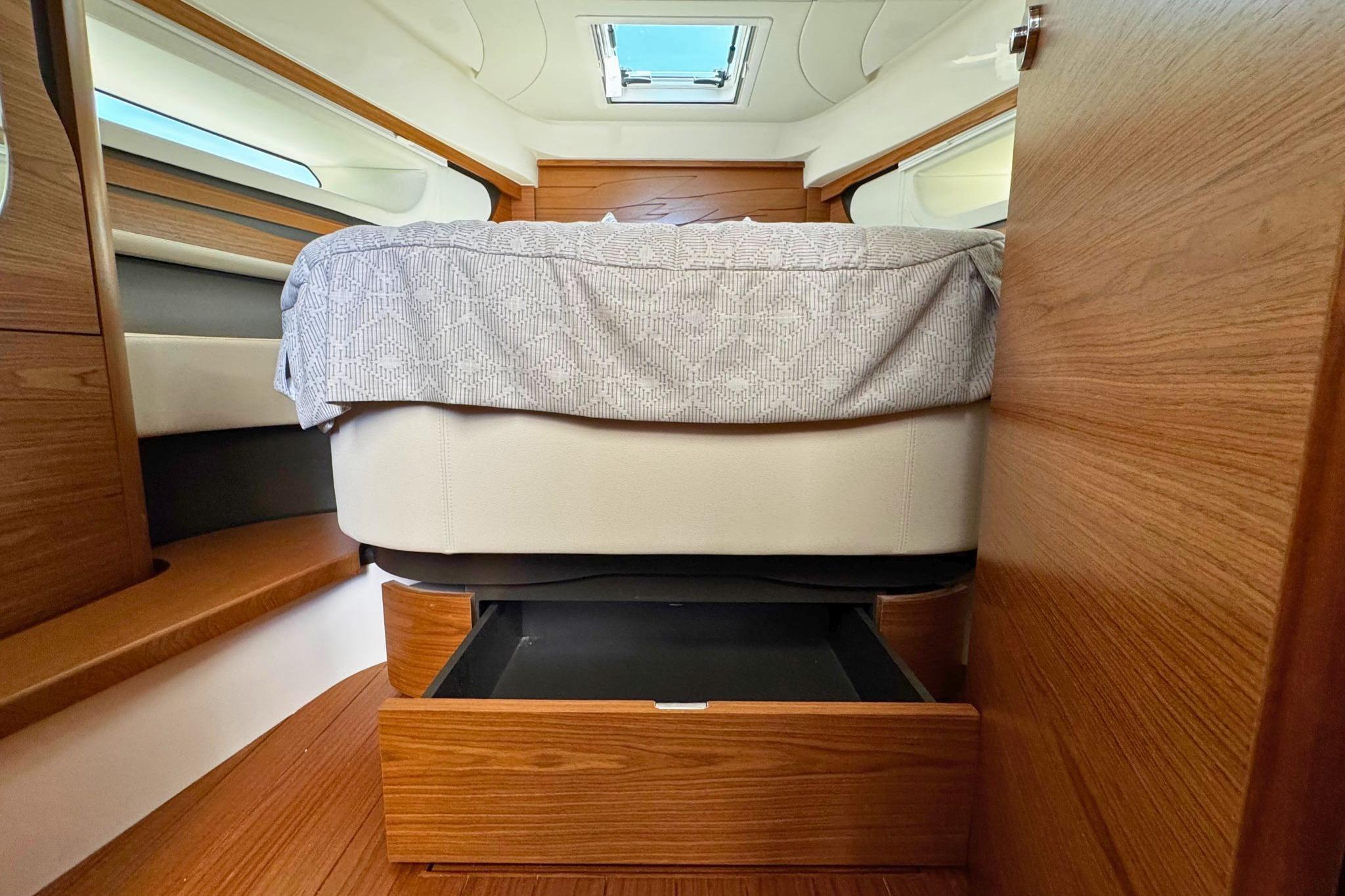 Interior cabin of 2027 Tiara Yachts 39 LE with bed and storage drawer.