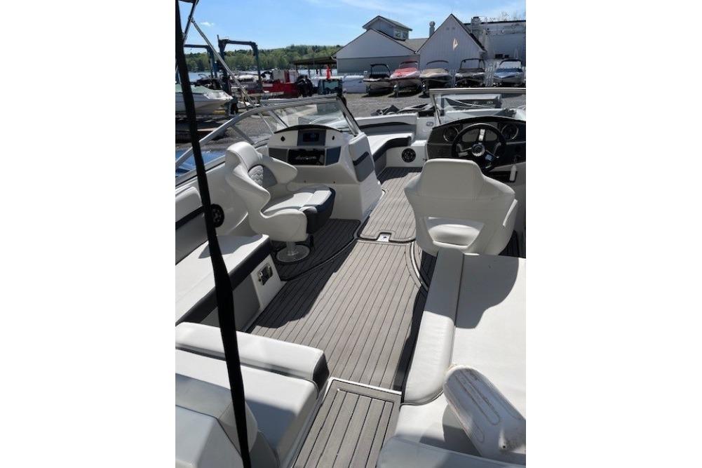 2023 Hurricane SunDeck 217 OB boat interior with seating and steering wheel.