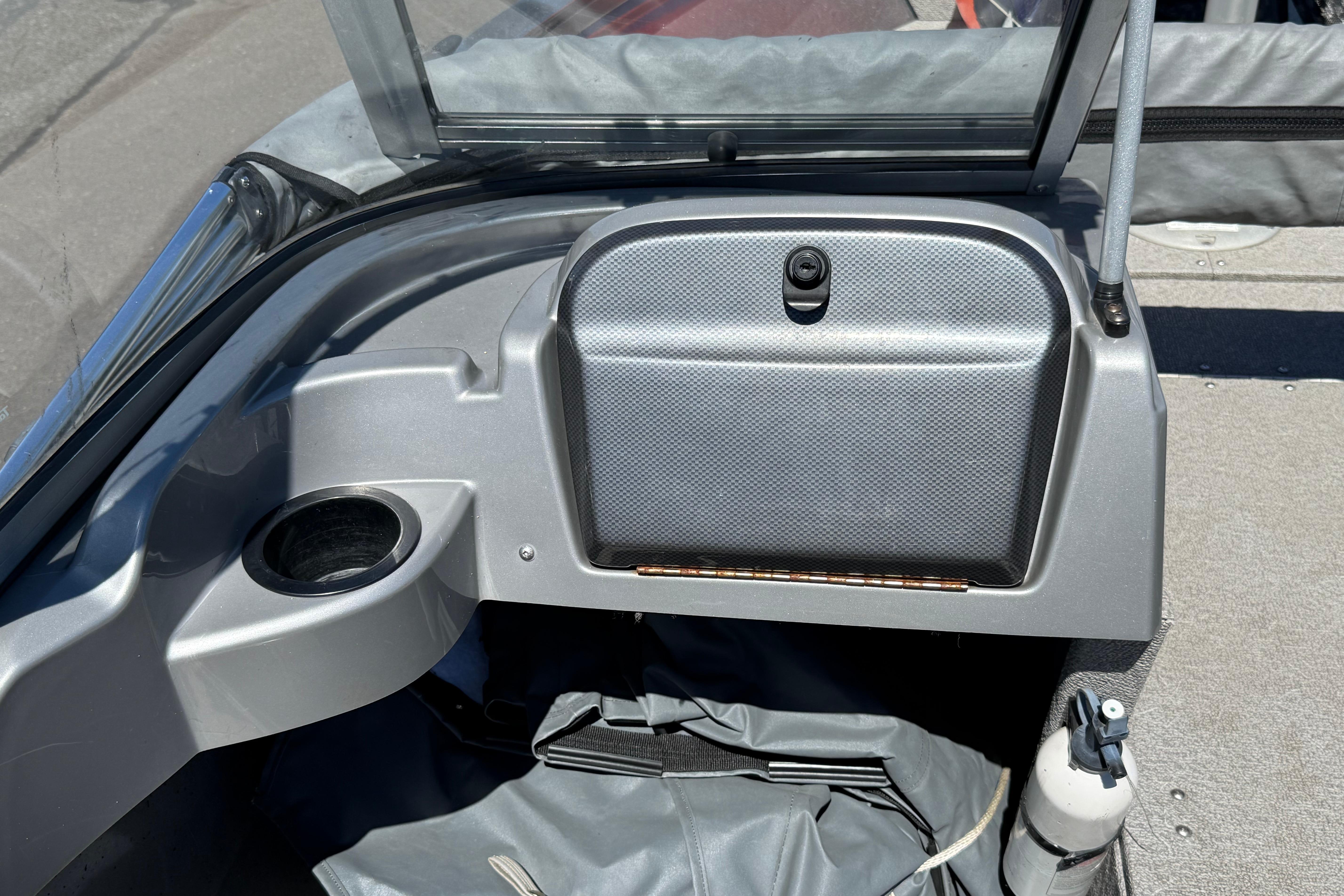 2016 Crestliner 1700 Vision boat dashboard with cup holder and storage compartment.