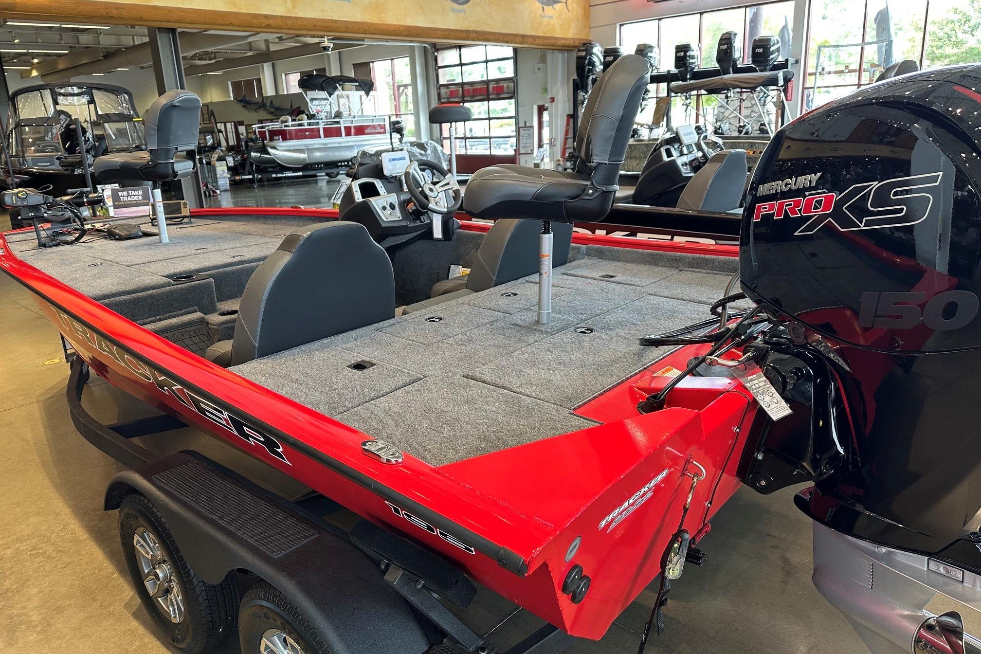 2026 Tracker Pro Team 195 boat with Mercury Pro XS engine in showroom.