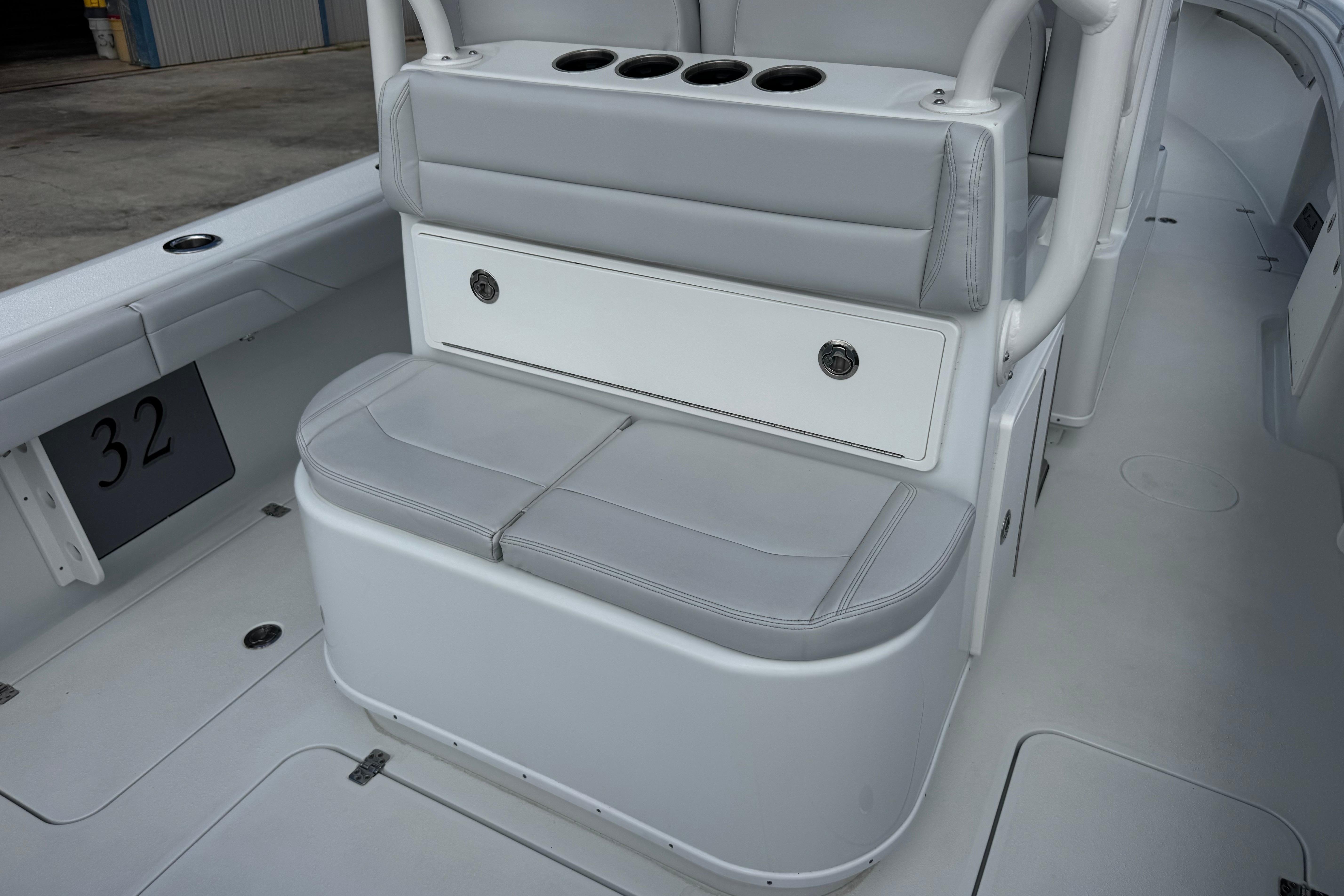 2022 Yellowfin 32 Offshore boat interior with gray seating and storage compartments.