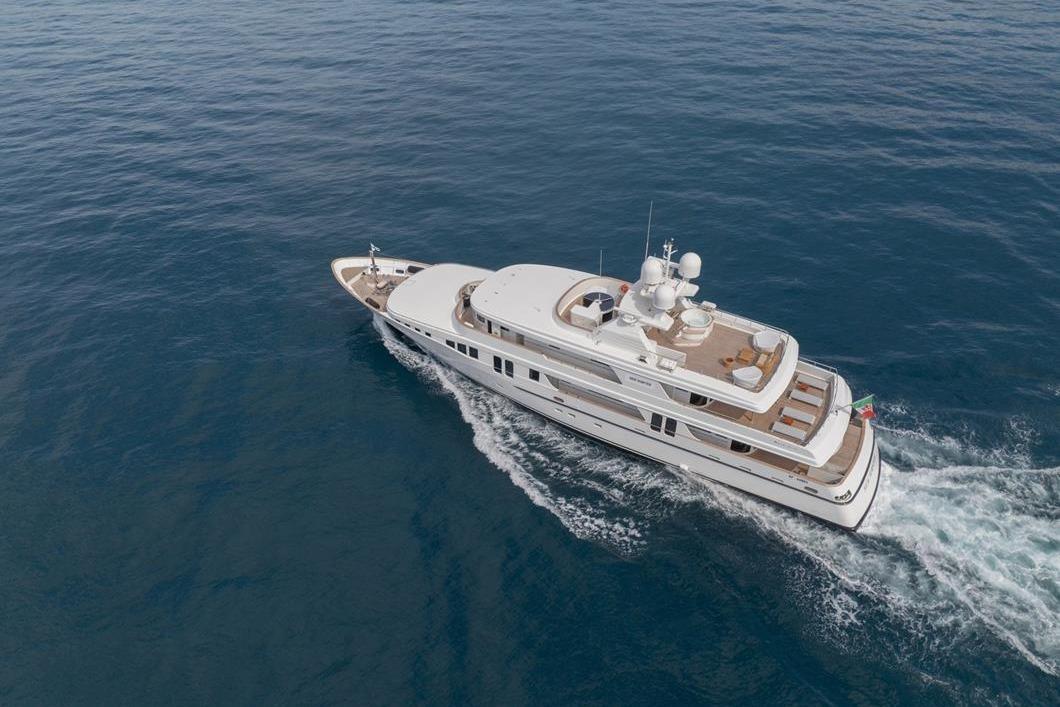 Aerial view of 2001 Baglietto New Master yacht cruising on open sea.