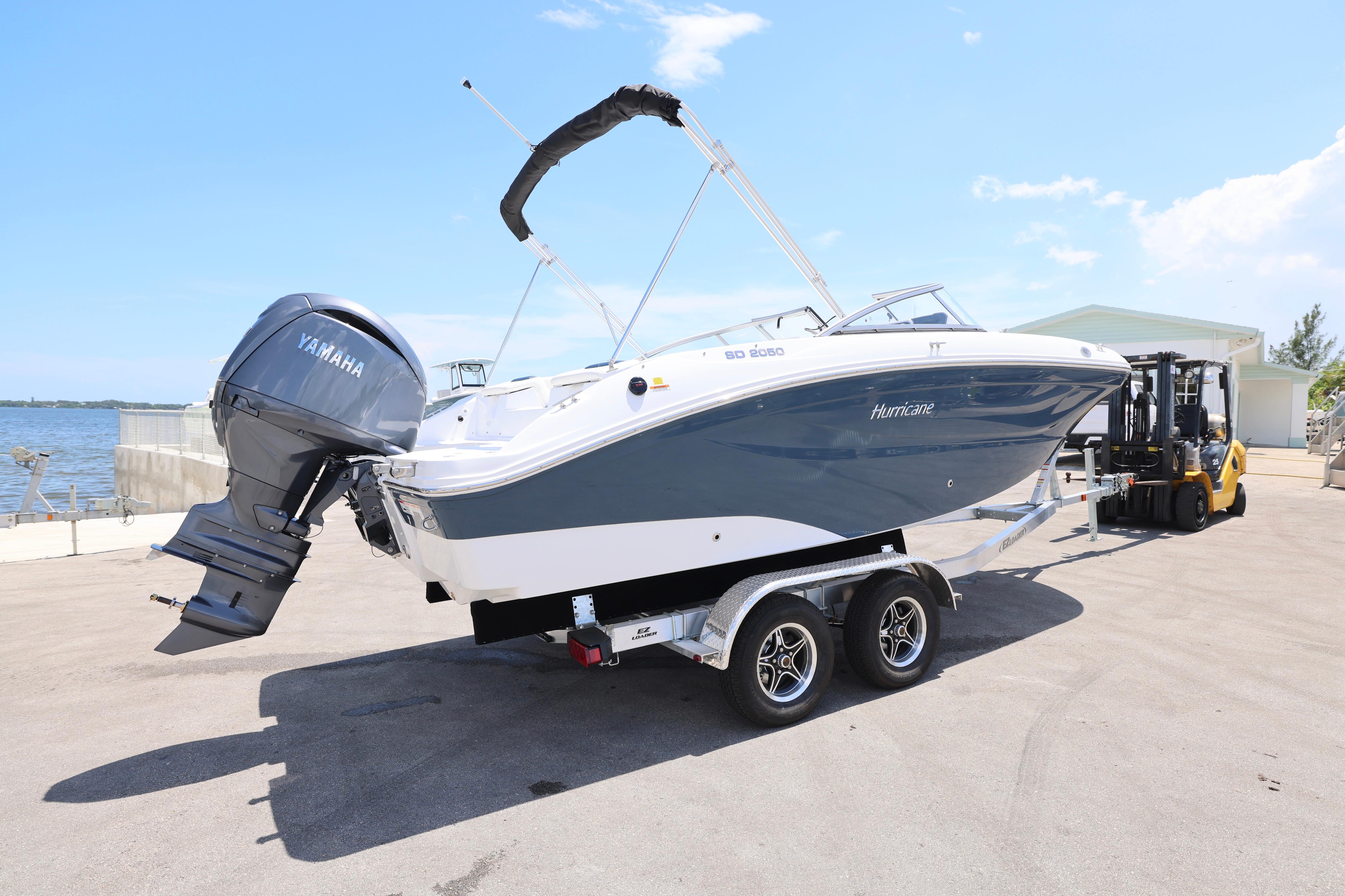 2026 Hurricane SunDeck 2050 OB boat on trailer, featuring Yamaha outboard motor.