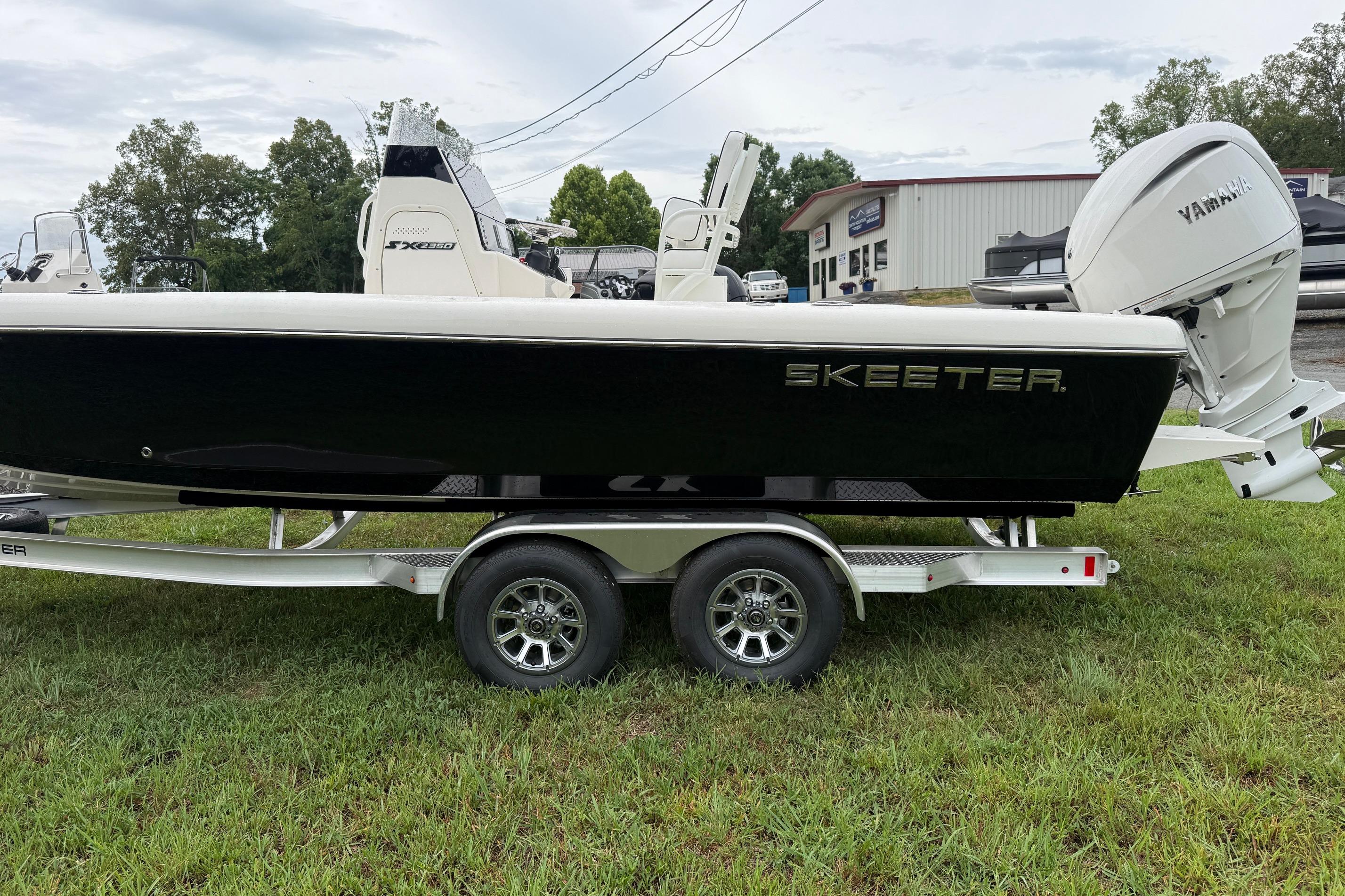 2026 Skeeter SX2350 boat on trailer with Yamaha engine, parked on grass.