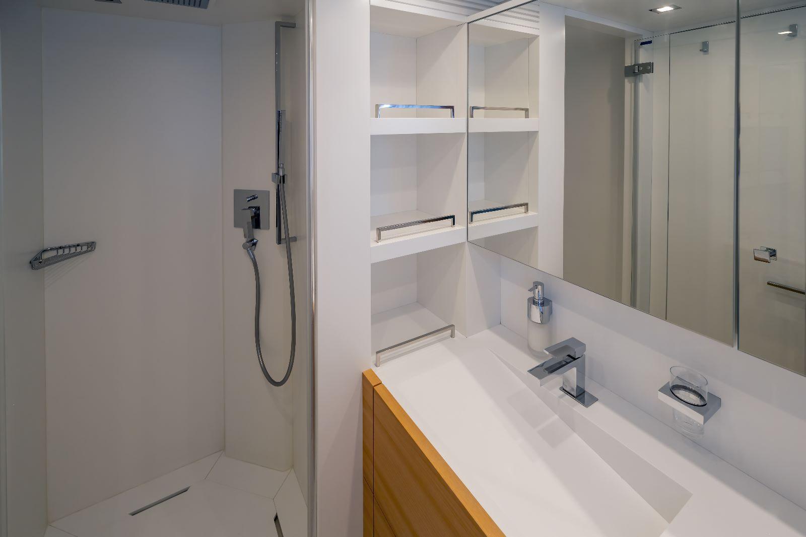 Modern bathroom interior on 2011 Maiora 27 yacht, featuring sleek fixtures and minimalist design.