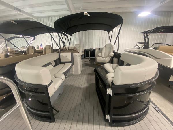 2024 Starcraft EXS 1 pontoon boat with spacious seating and black canopy.