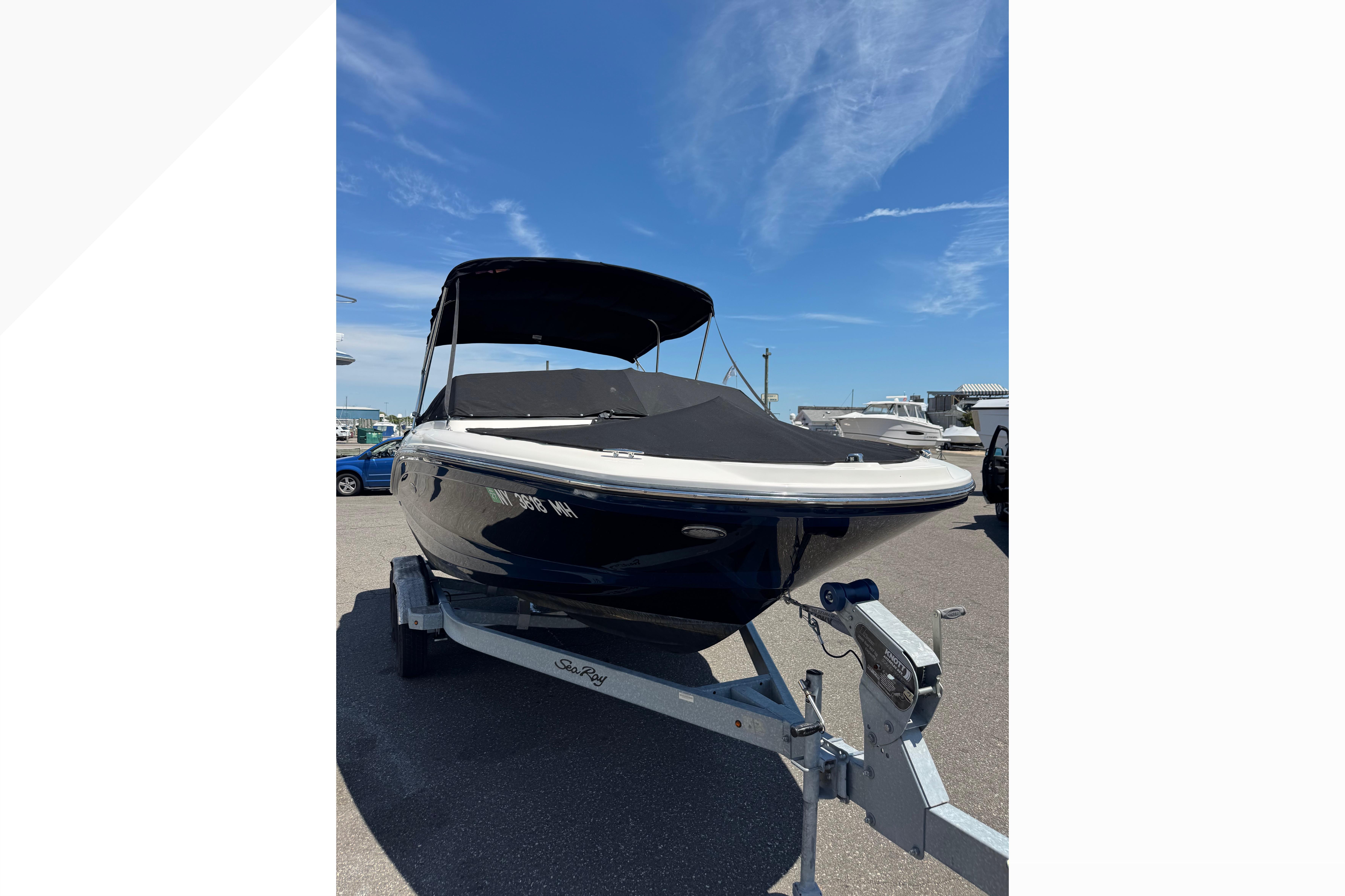 2021 Sea Ray SPX 190 boat on trailer under clear blue sky.