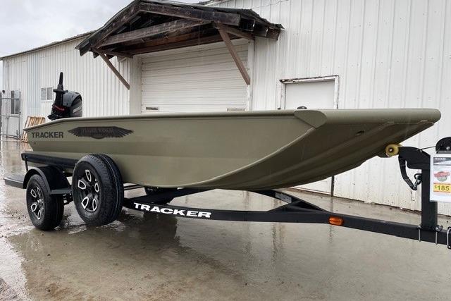 2026 Tracker Grizzly 1650 T Prairie Wings Edition boat on trailer, parked outside.