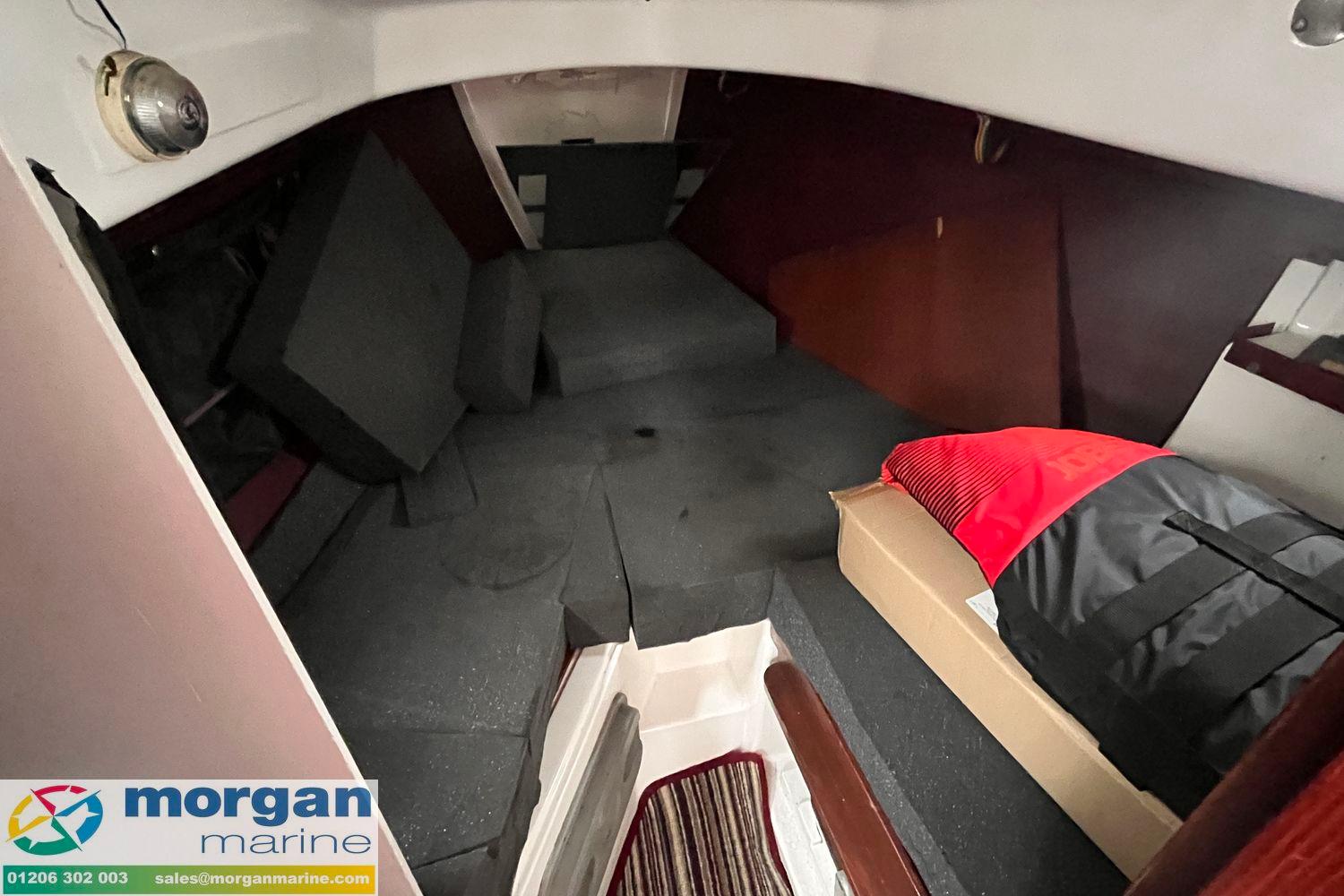 Interior of a 1979 Leisure 23 boat cabin with cushions and storage.