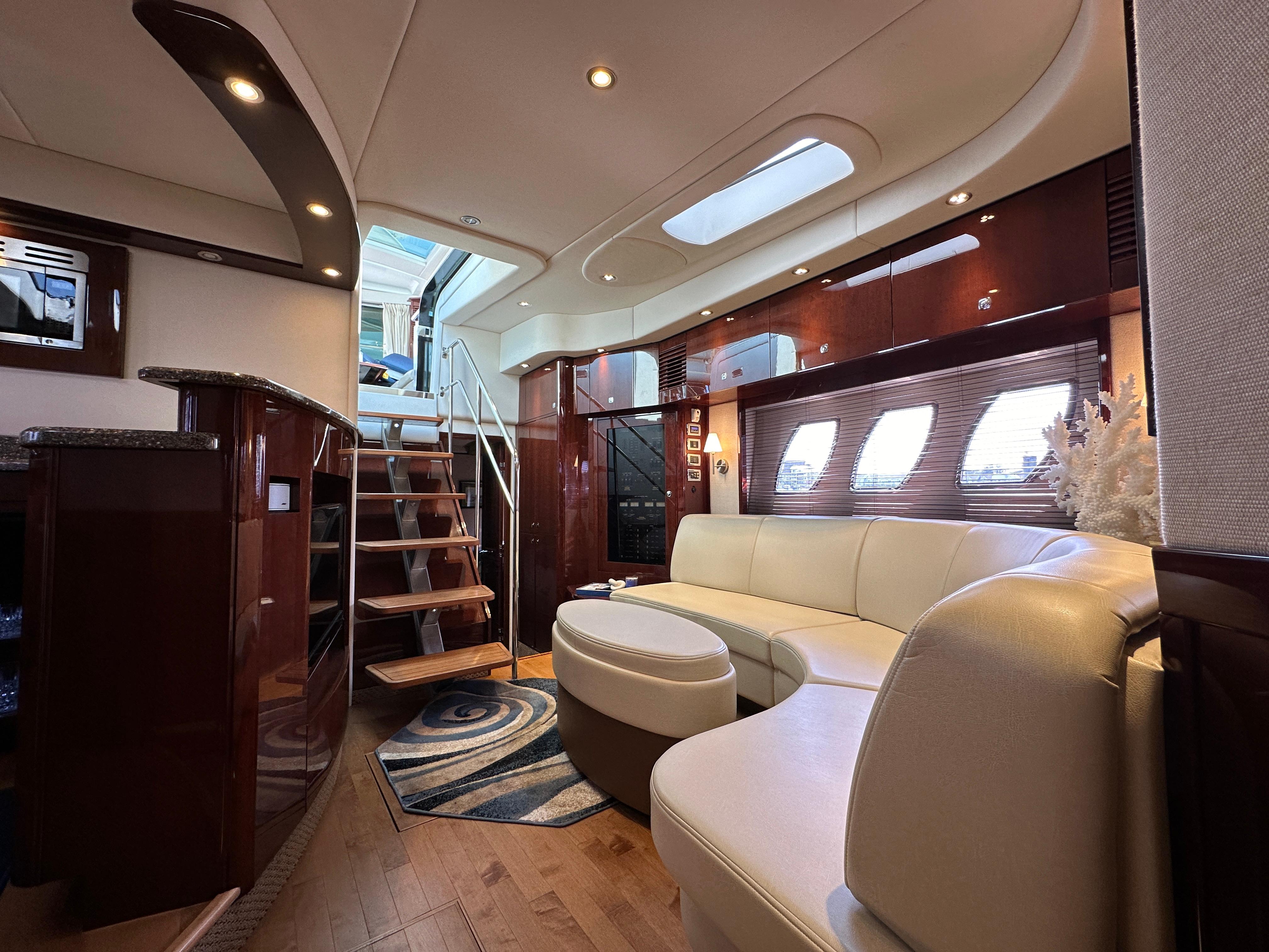 Luxurious interior of 2009 Sea Ray 60 Sundancer yacht with elegant seating and wooden accents.