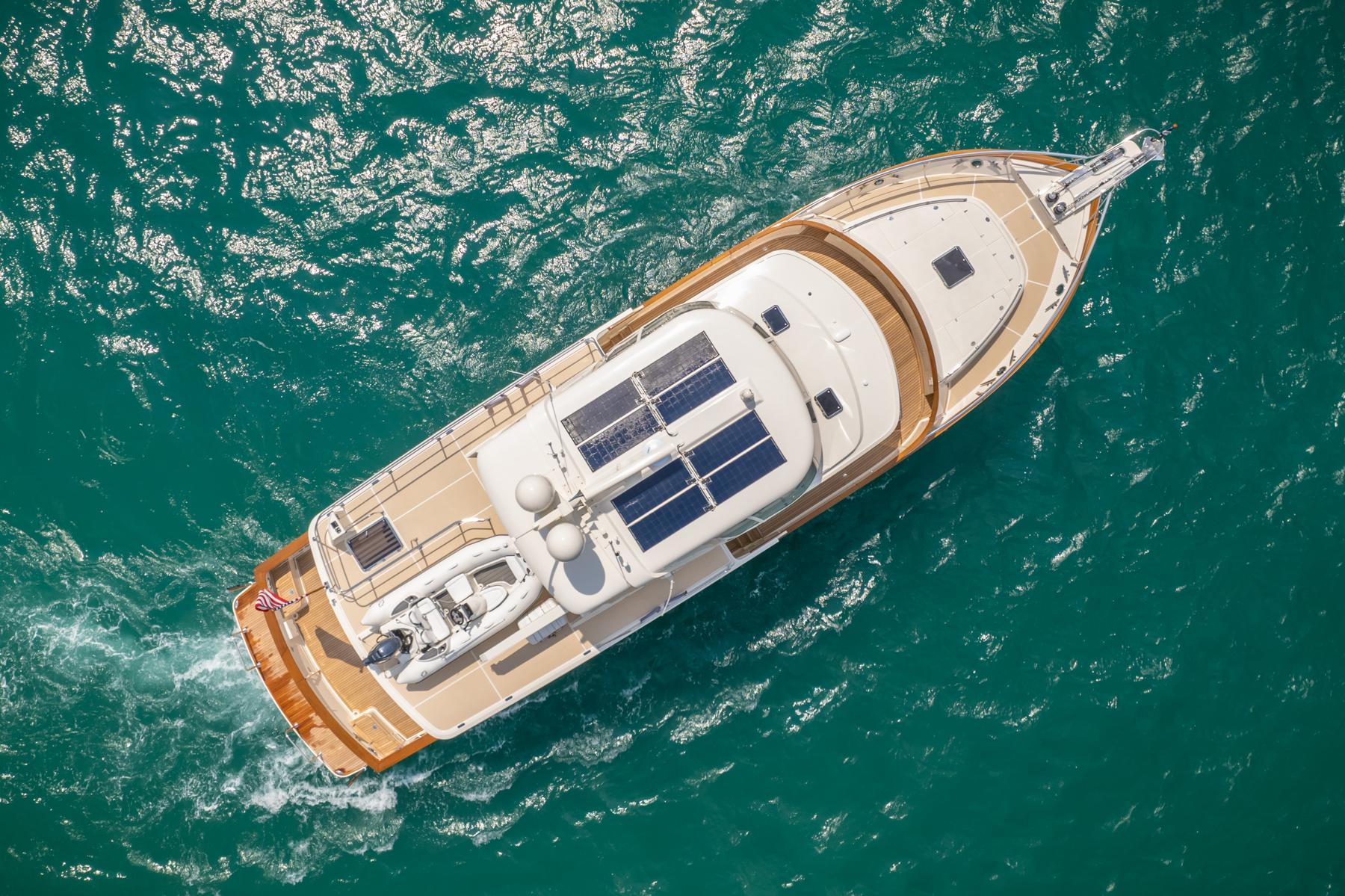 Aerial view of 2027 Fleming 65 yacht cruising on turquoise waters.