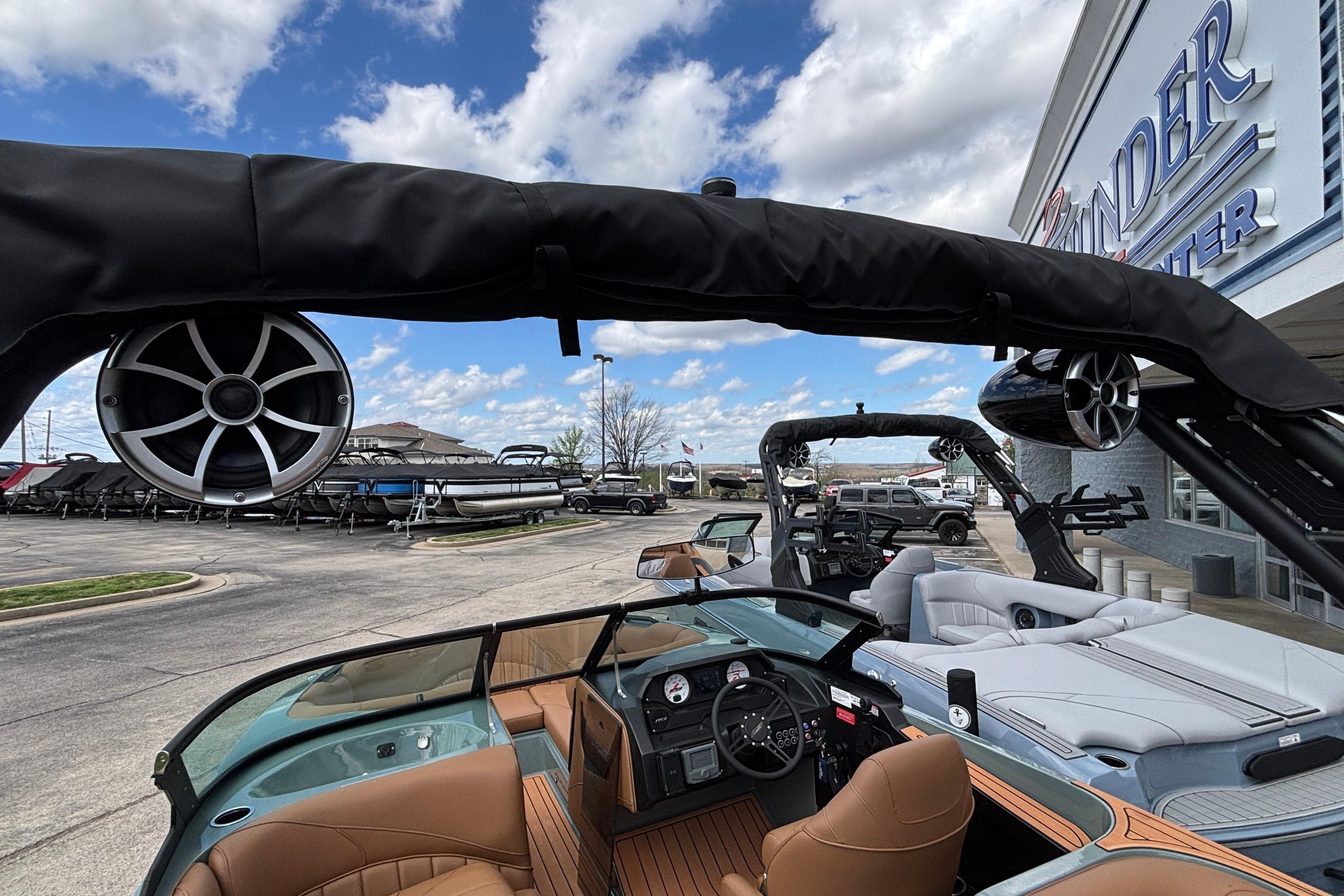 2026 MB B52 23 Classic boat with luxury interior and speakers, displayed at a dealership.