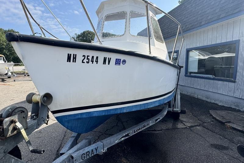 2001 ROS Boats 19 RUNABOUT on trailer, parked outside a building.