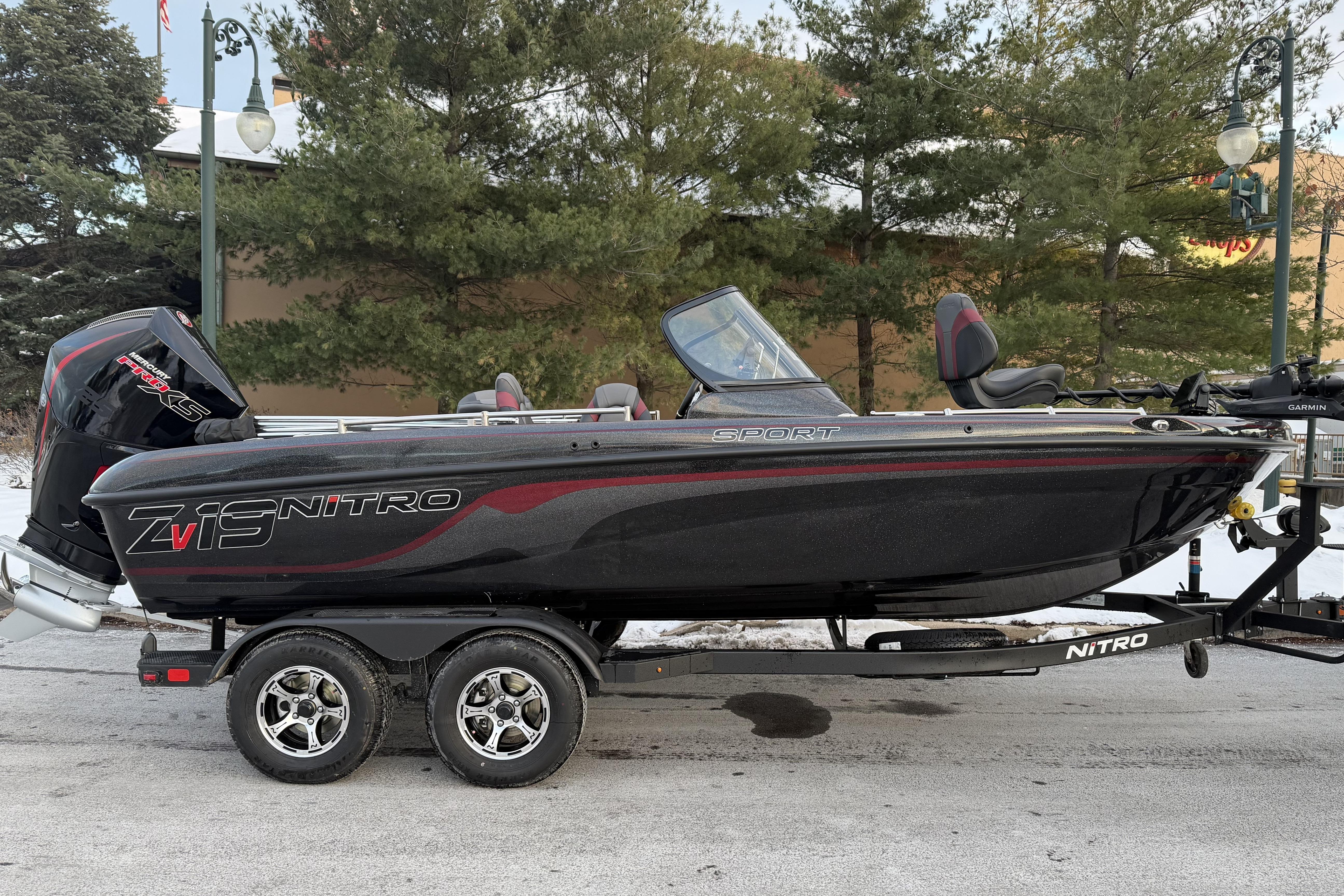2026 Nitro ZV19 Sport Pro boat on trailer, parked outdoors.