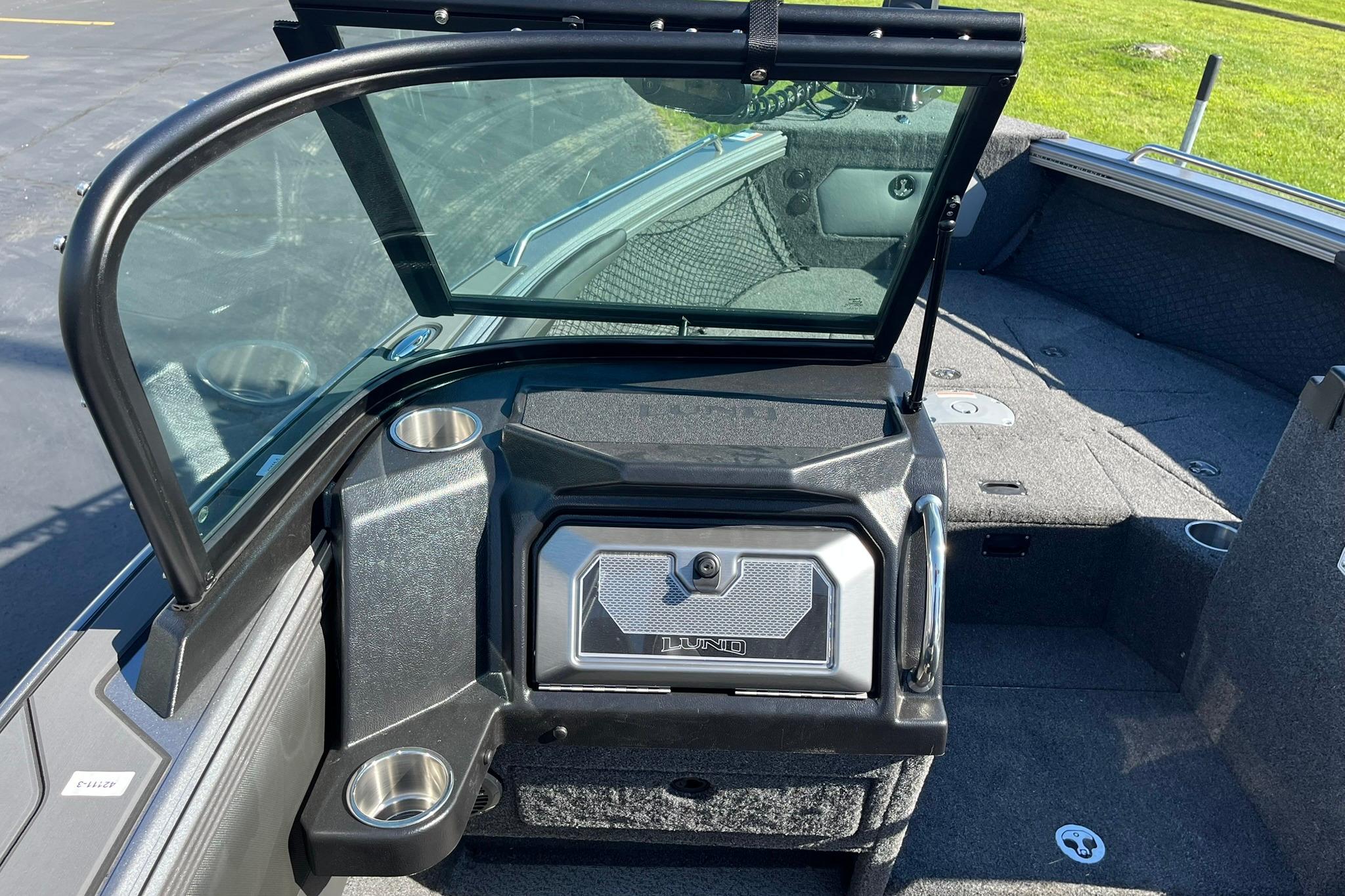 2026 Lund 2275 Baron boat interior with windshield and storage compartment.