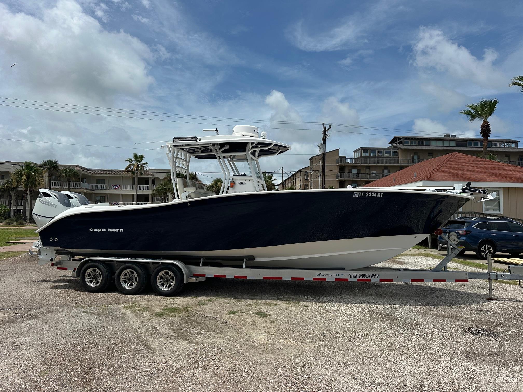 2023 Cape Horn 32xs boat on trailer, parked outdoors under a cloudy sky.
