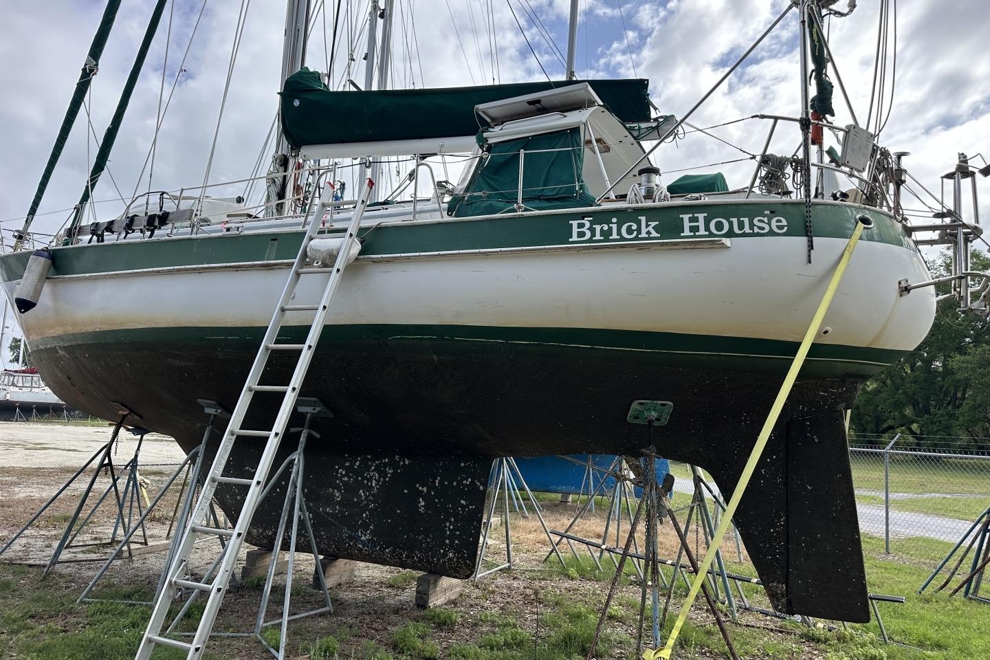 1976 Valiant 40 sailboat "Brick House" on dry dock with ladder access.