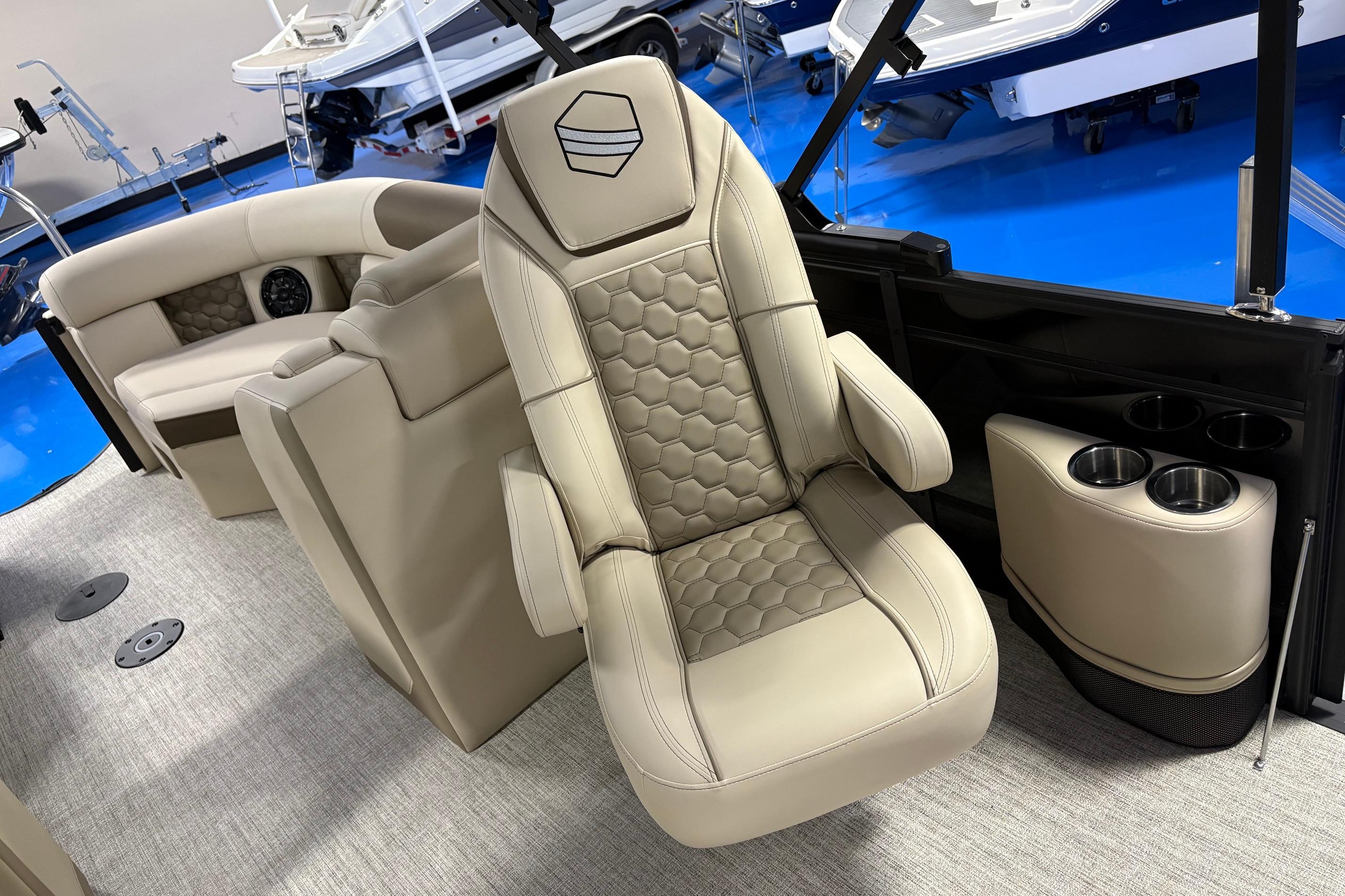 Luxurious interior of 2026 South Bay 523RS boat with plush seating and cup holders.