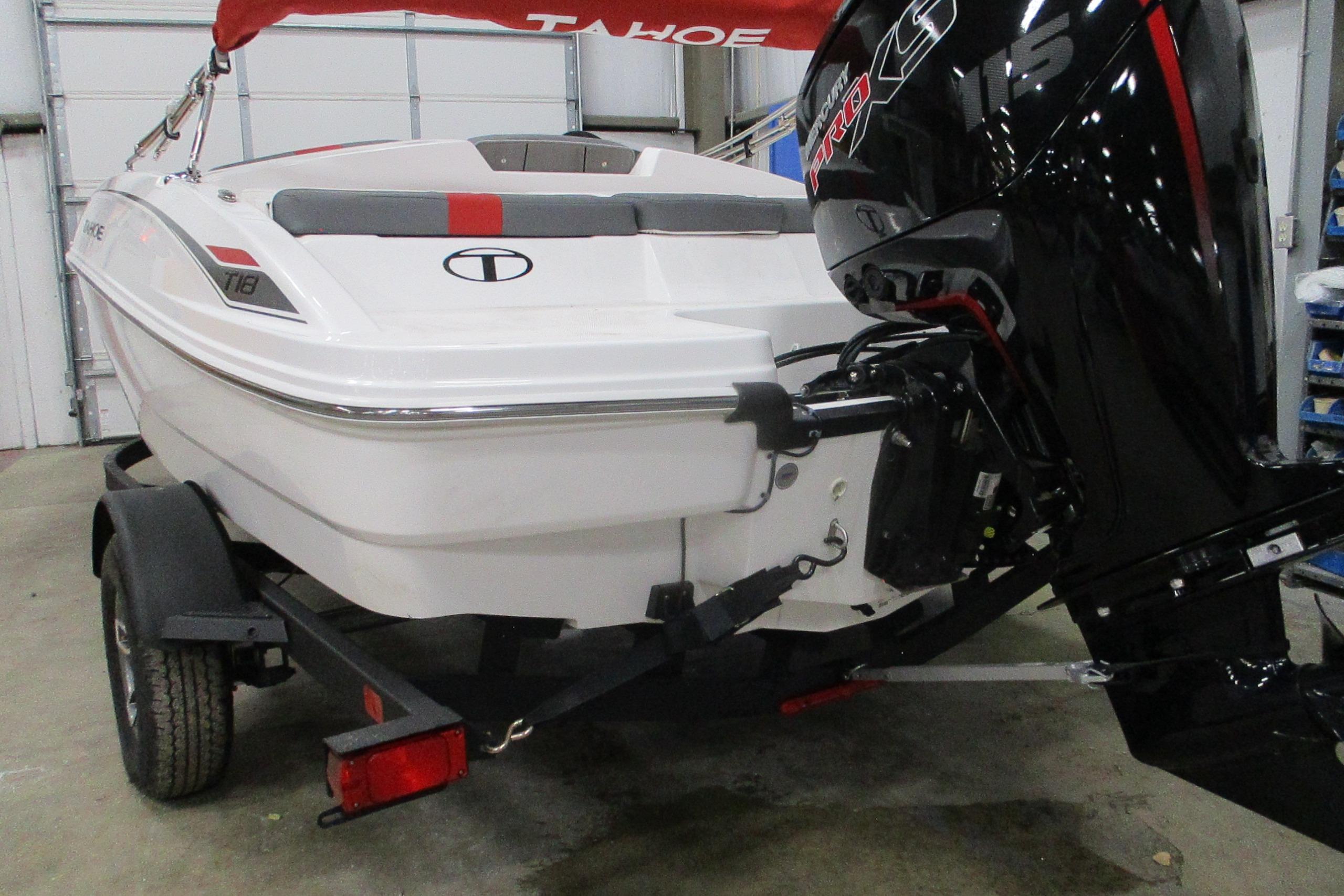 2025 Tahoe T18 boat with powerful outboard motor in a garage setting.
