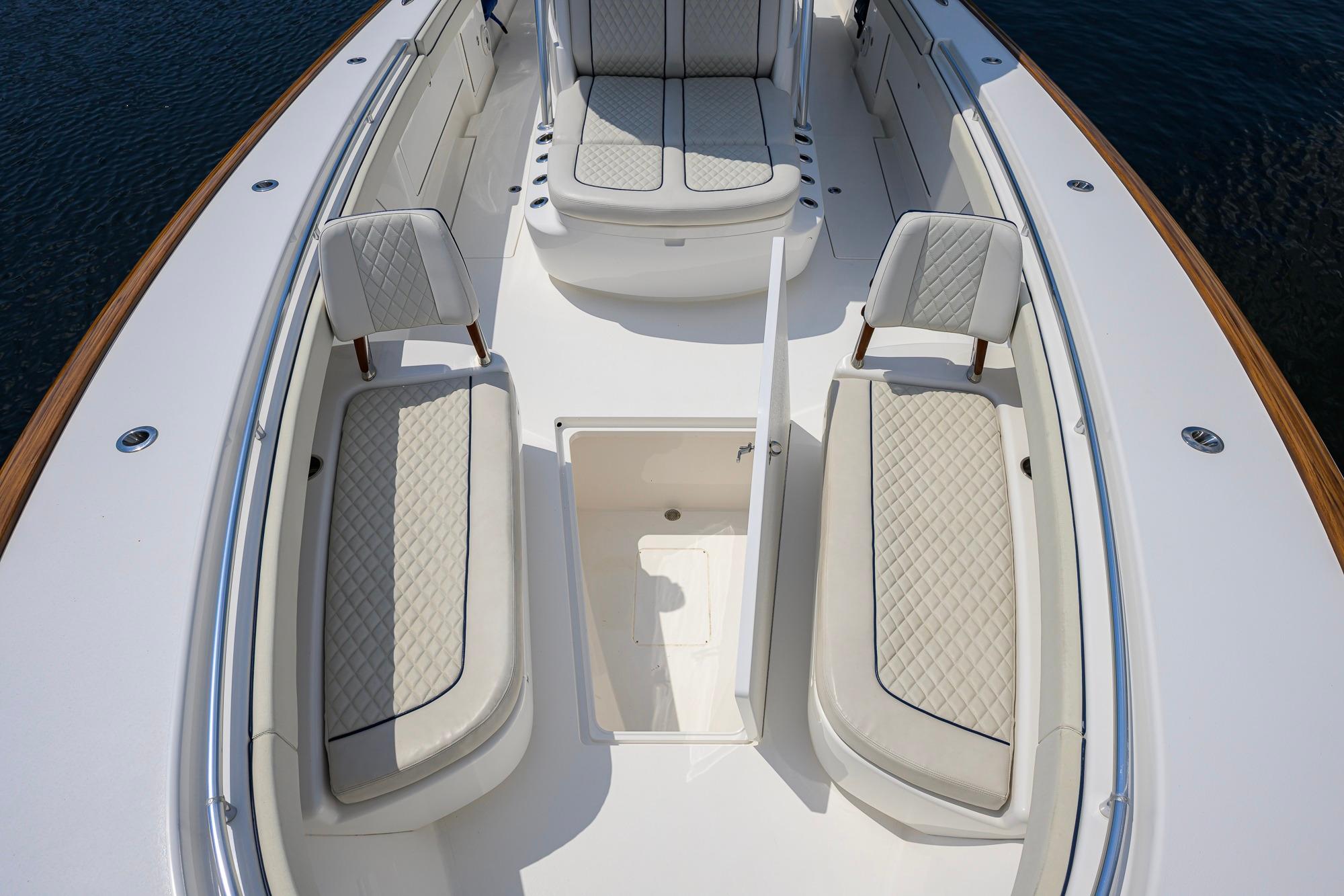 2020 Valhalla Boatworks V-41 interior with cushioned seating and storage compartment.