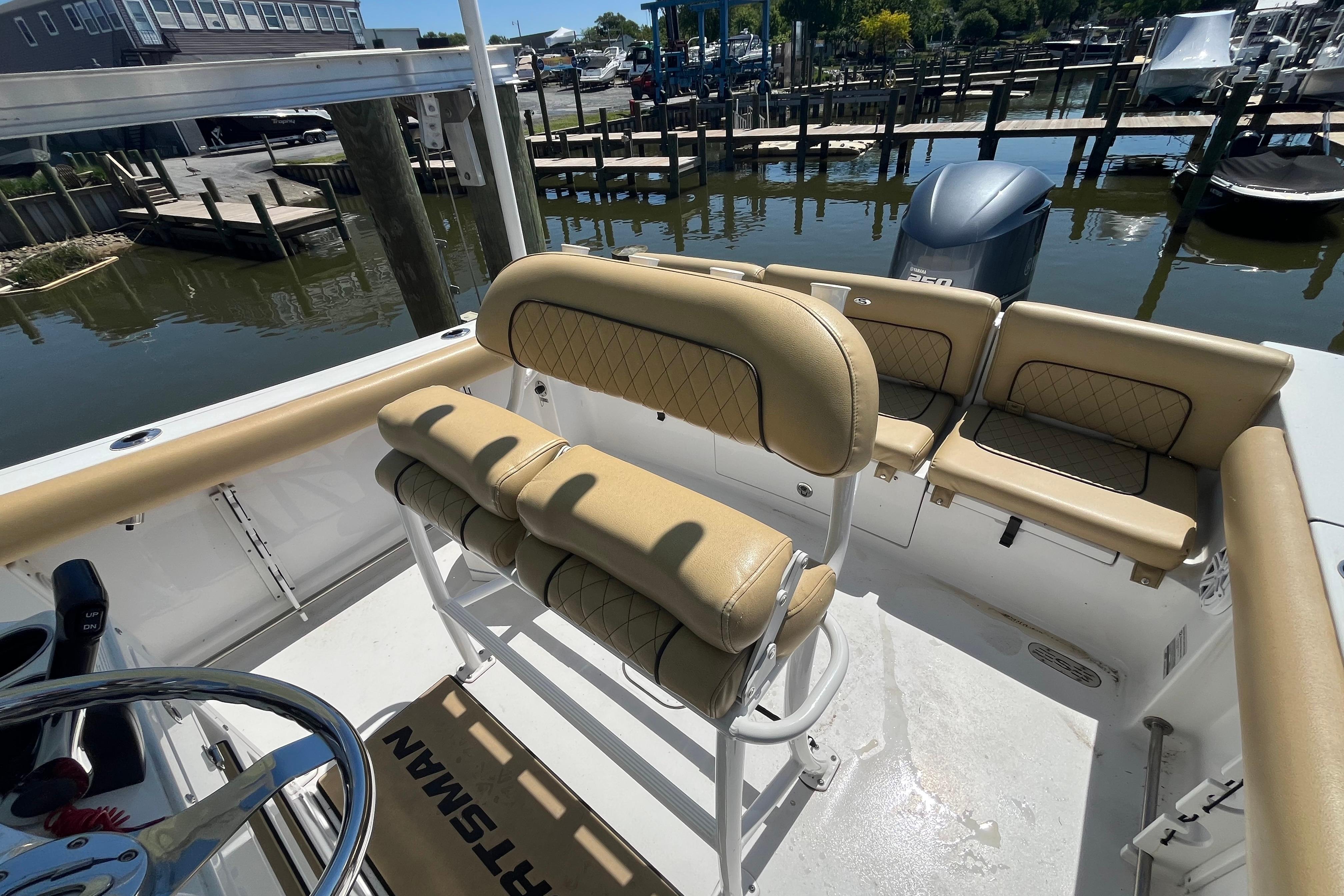 2021 Sportsman Heritage 231 Center Console boat interior with tan seating and steering wheel.