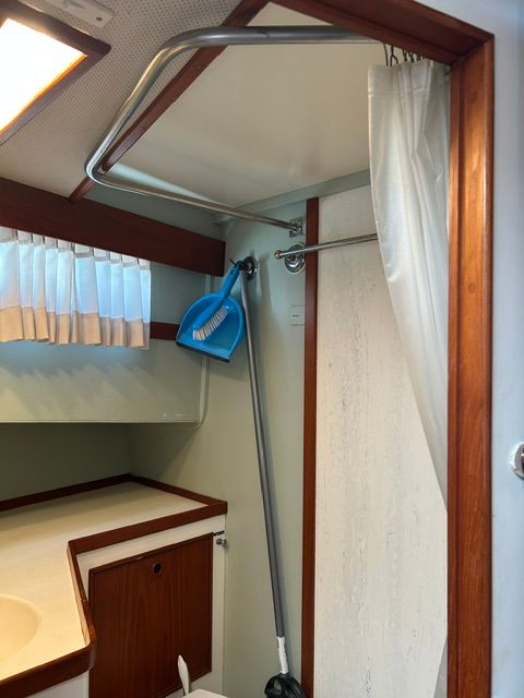 Interior of a 1980 Grand Banks 32 Sedan, bathroom with shower curtain.