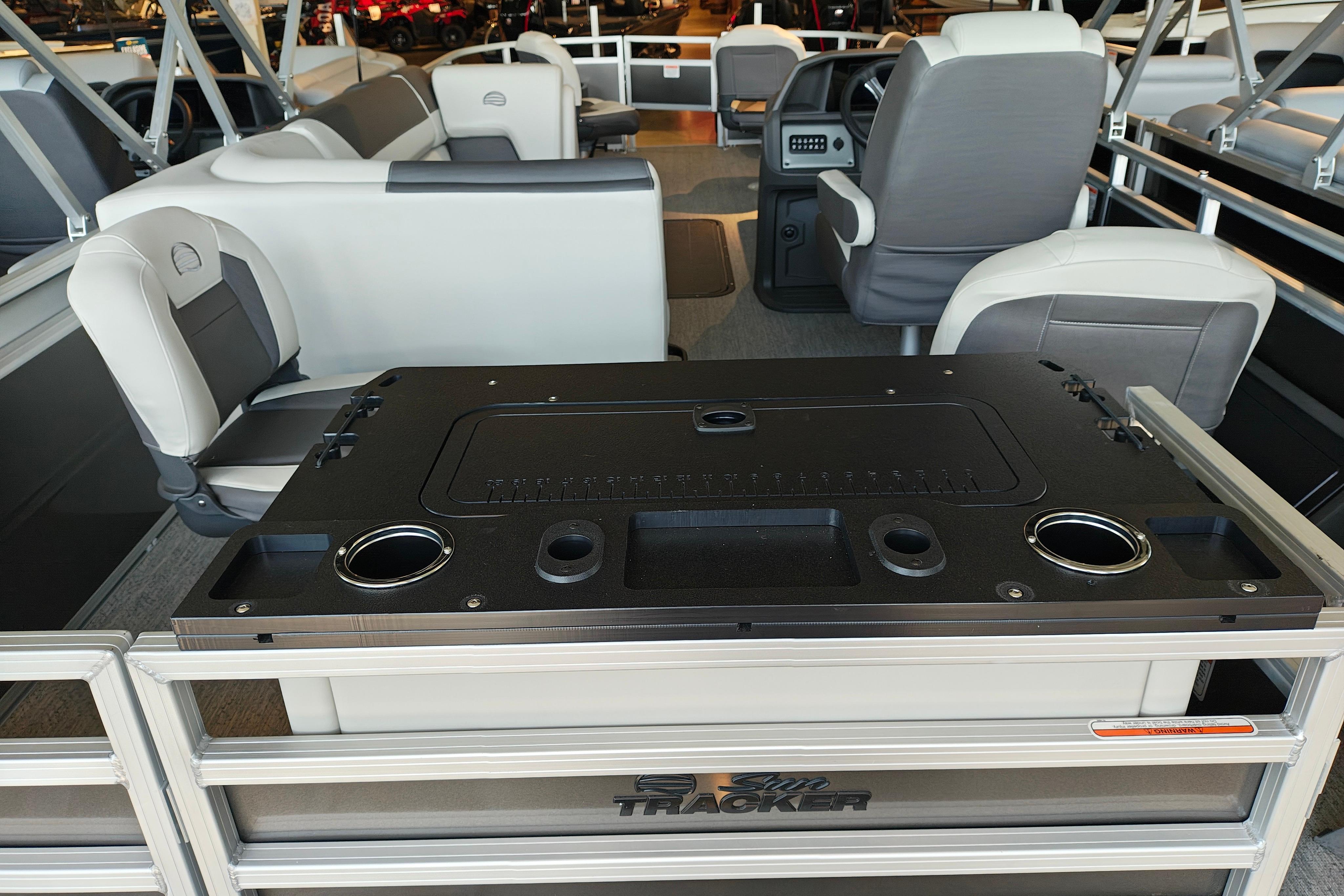 2026 Sun Tracker Fishin' Barge 22 XP3 interior with seating and control panel.