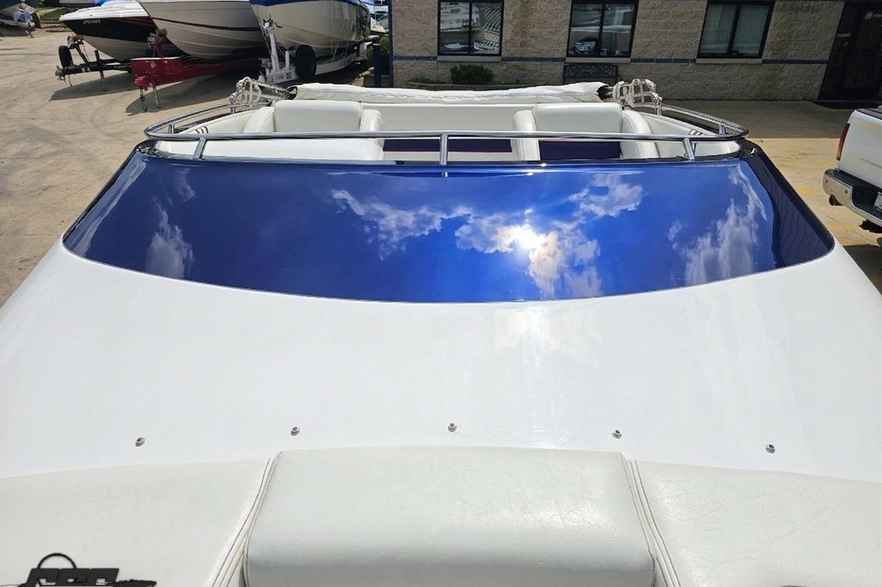 2019 Advantage 25 Citation Bowrider with reflective blue windshield, parked outdoors.